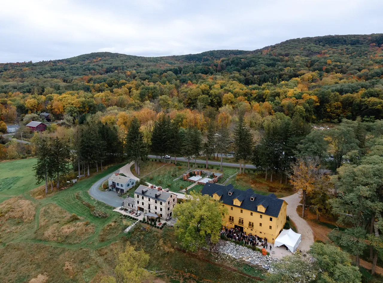 Aerial view of The Ruins at Sassafras — the chair factory, stone house, and gardens amid autumn hills
