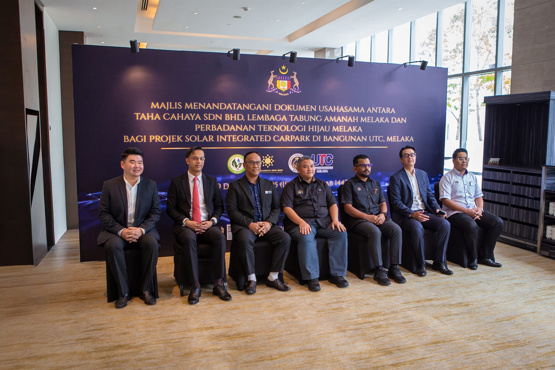 Government representatives and project partners at the Integrated Solar Carpark signing ceremony at UTC Melaka