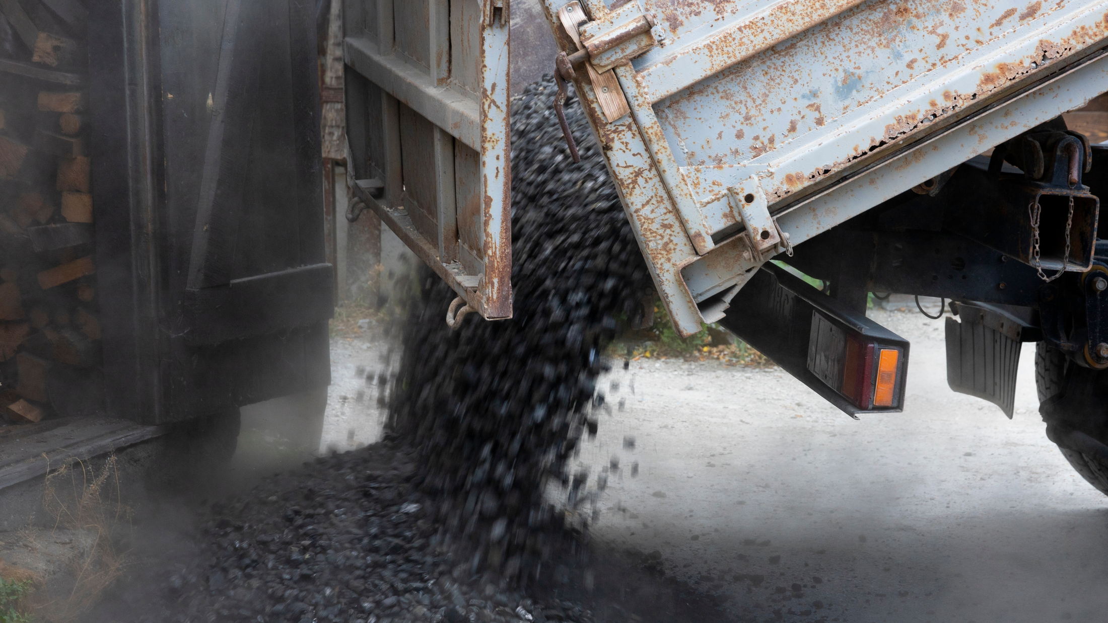 A tipper truck discharging a load of aggregate at a road works site