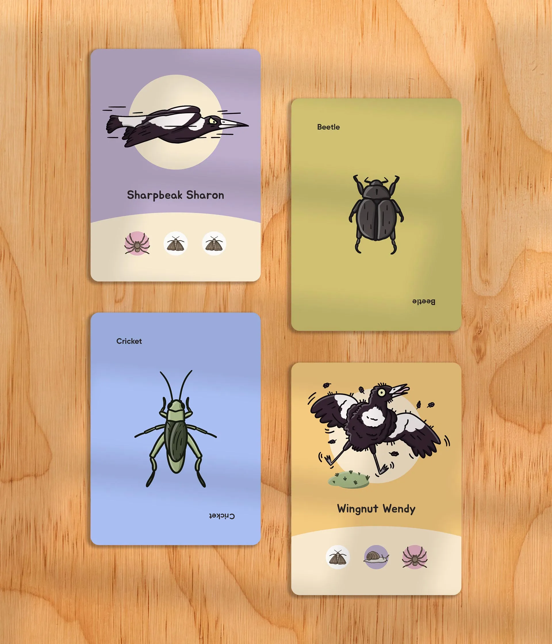 Swoopy Season magpie and critter cards laid out on a wooden table
