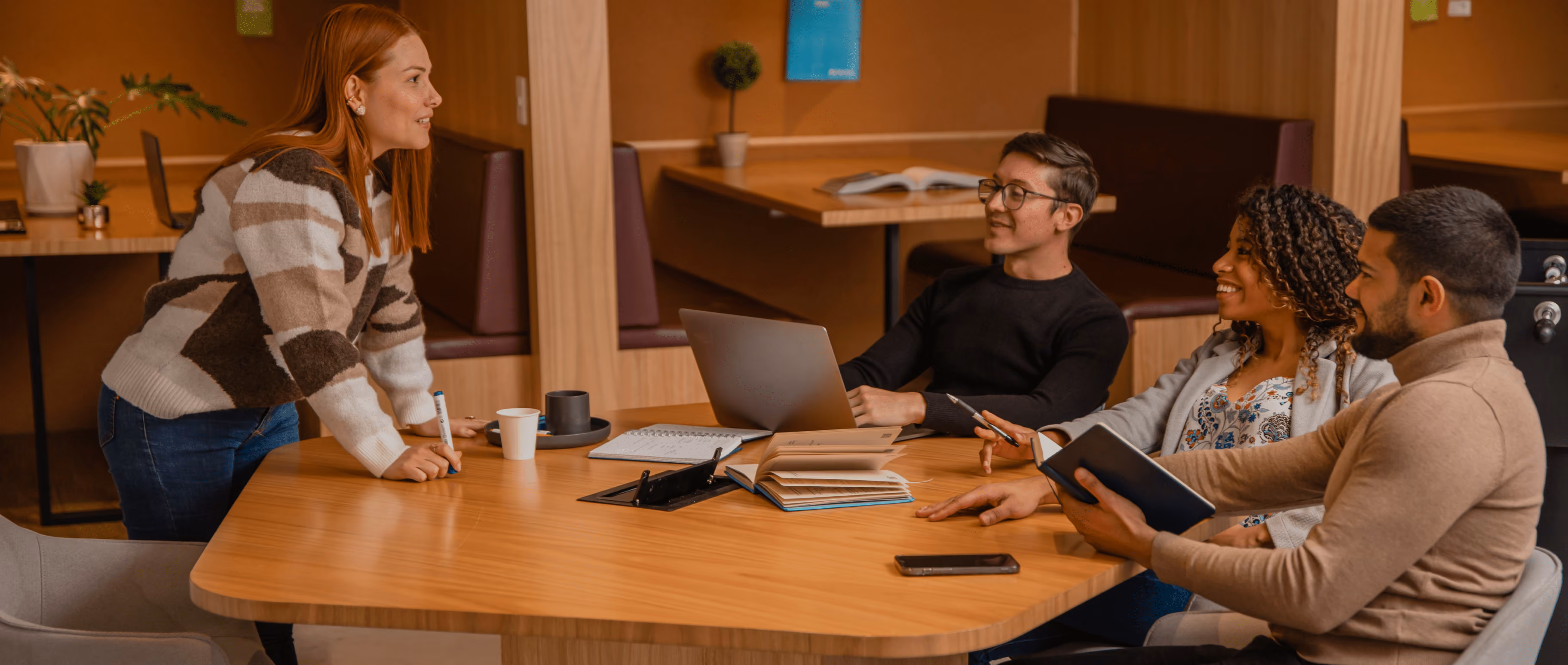 Team meeting around a table in a casual office setting