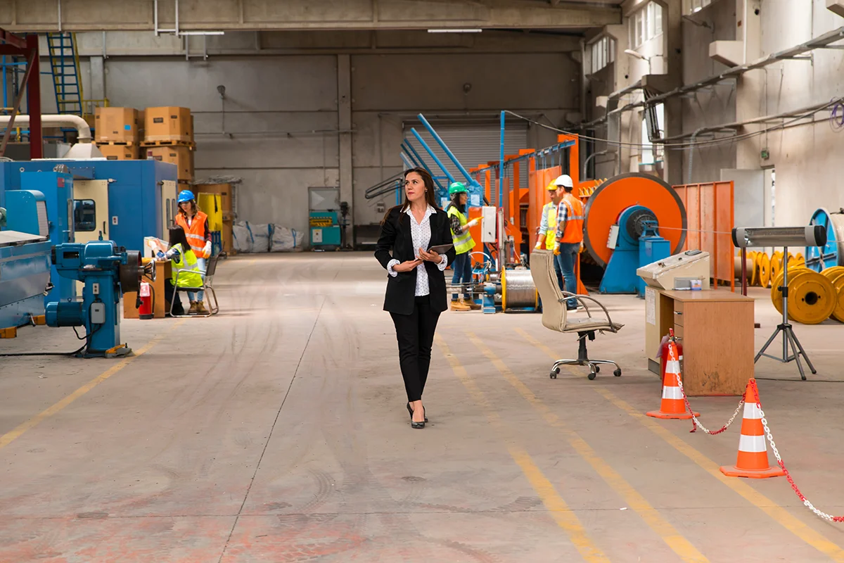 An operating leader walking the floor of a manufacturing facility.