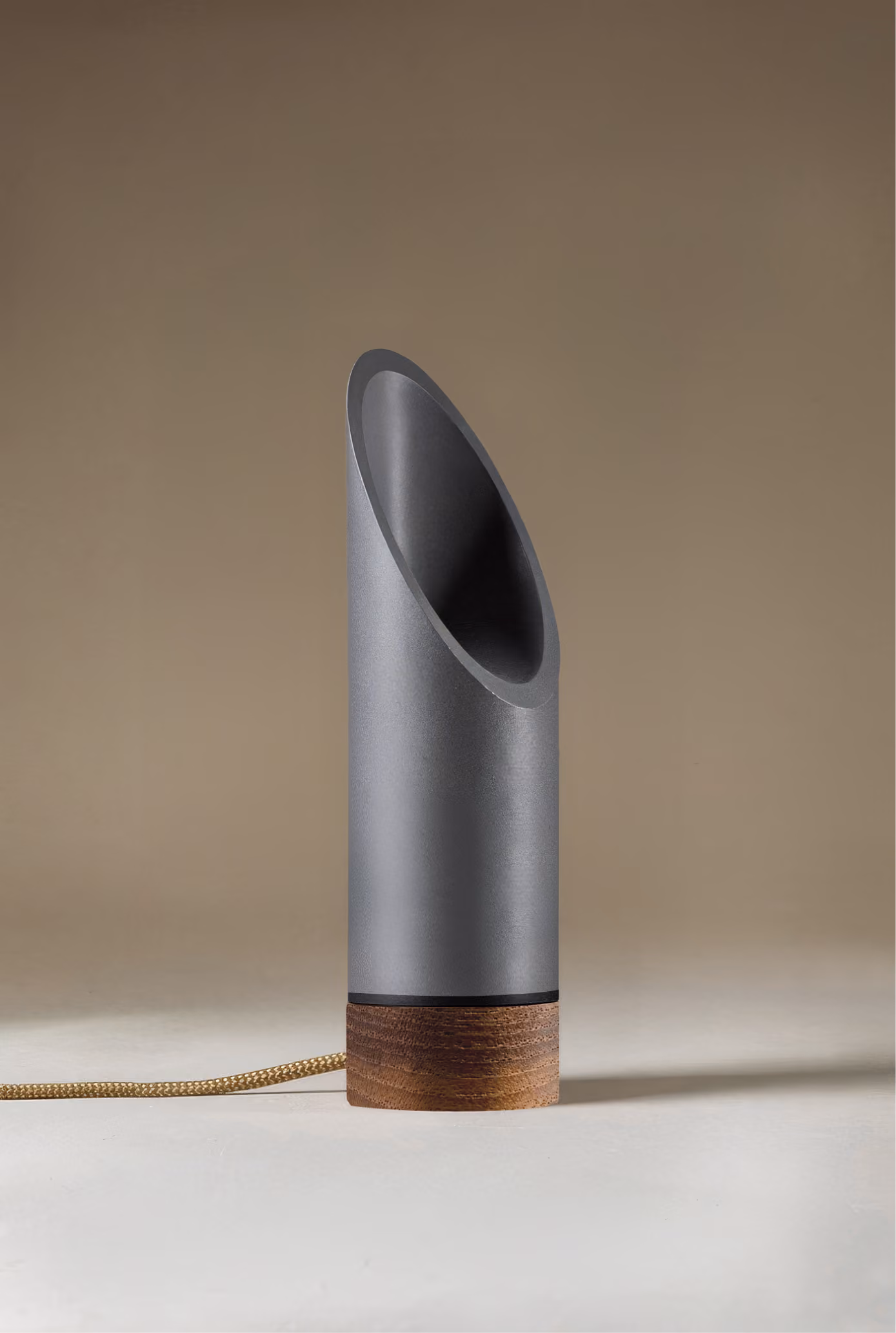 Crafted from salvaged skateboard half-pipe sections with warm copper accents.