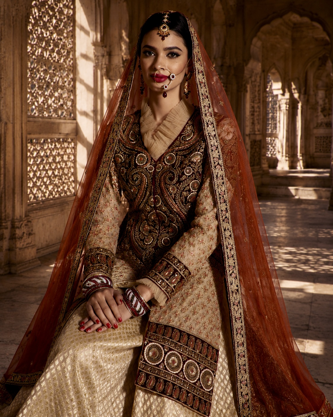 Seated view of richly embroidered bridal ensemble from Heirloom by Alia Qureshi Atelier