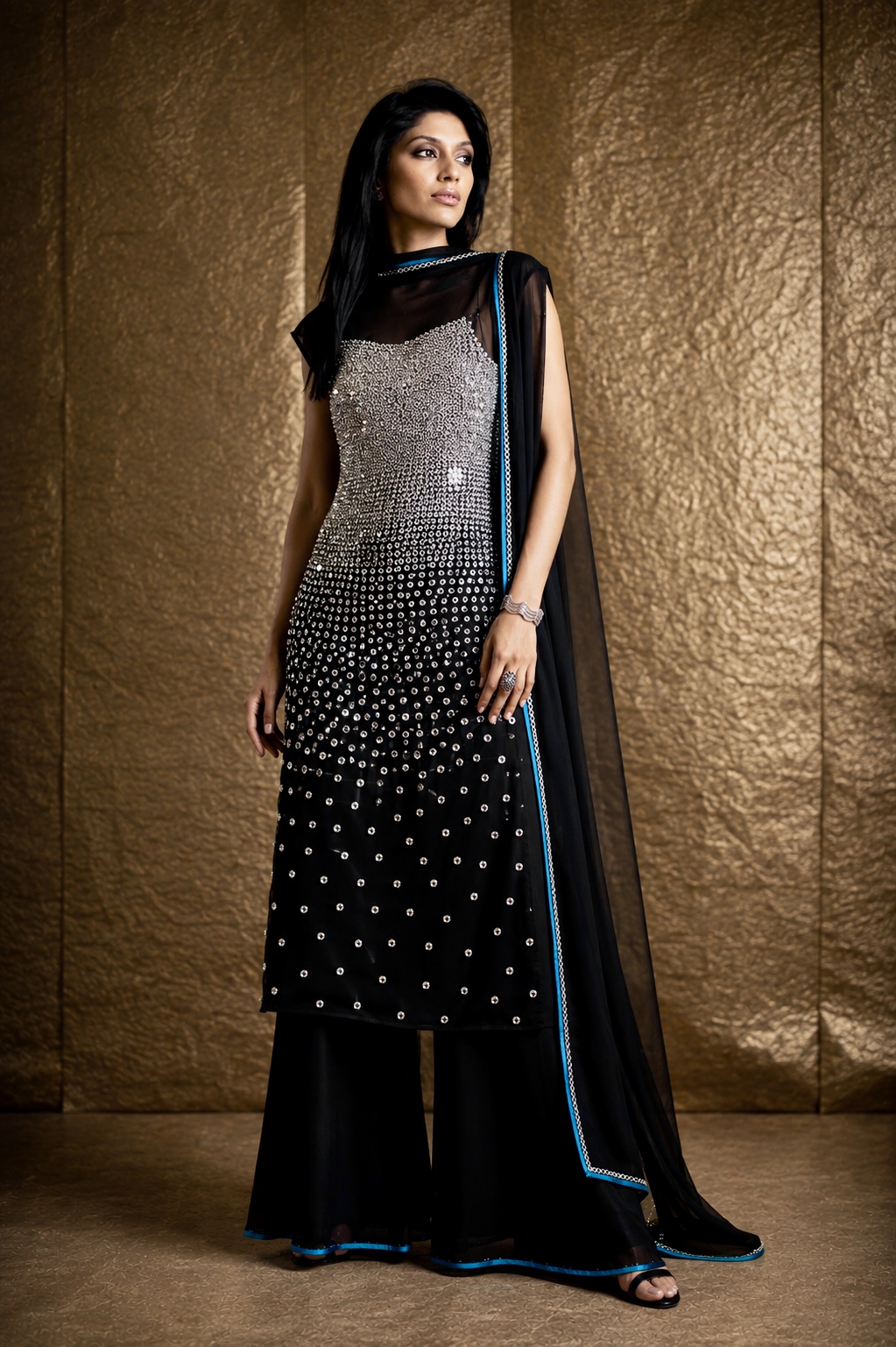 Black couture ensemble with scattered silver embellishment from Silver Eclipse by Alia Qureshi Atelier
