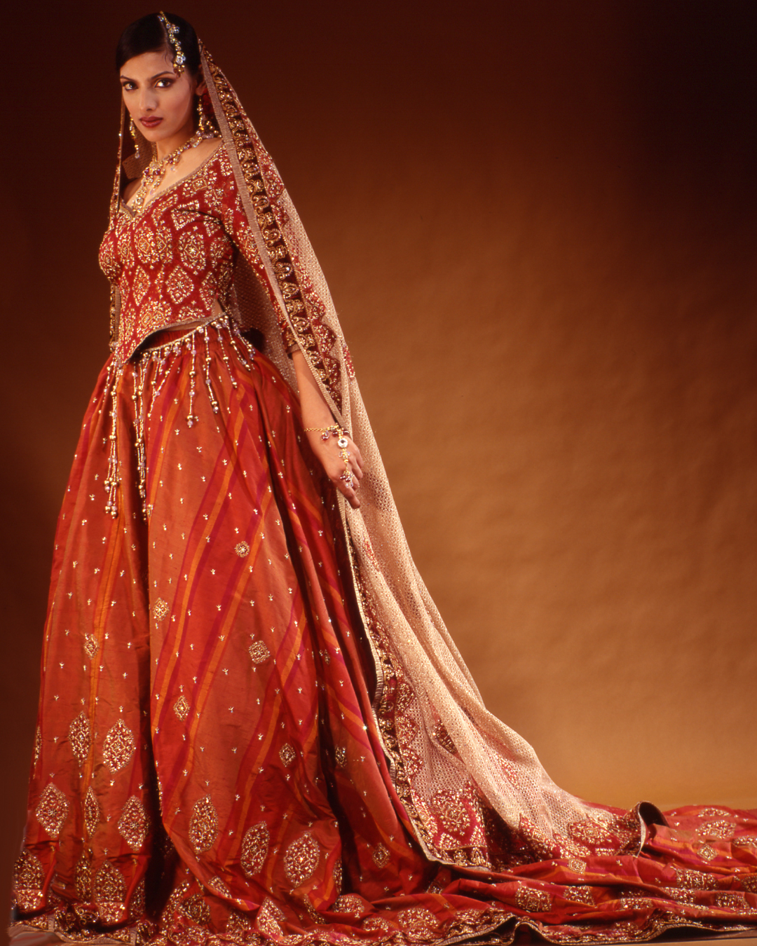 Model wearing dramatic red couture gown from an early Alia Qureshi runway collection