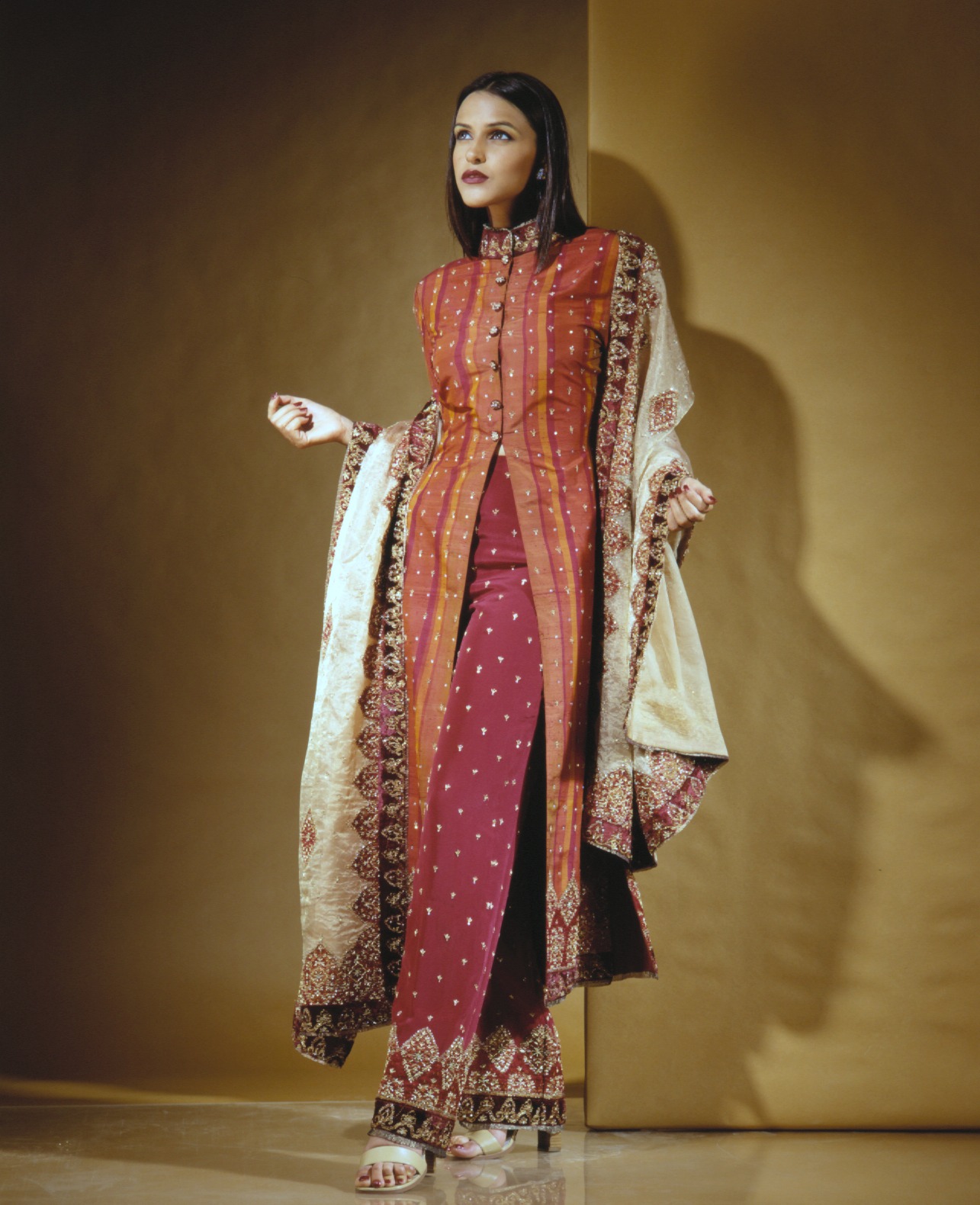 Model wearing red embroidered ensemble from an early Alia Qureshi runway collection
