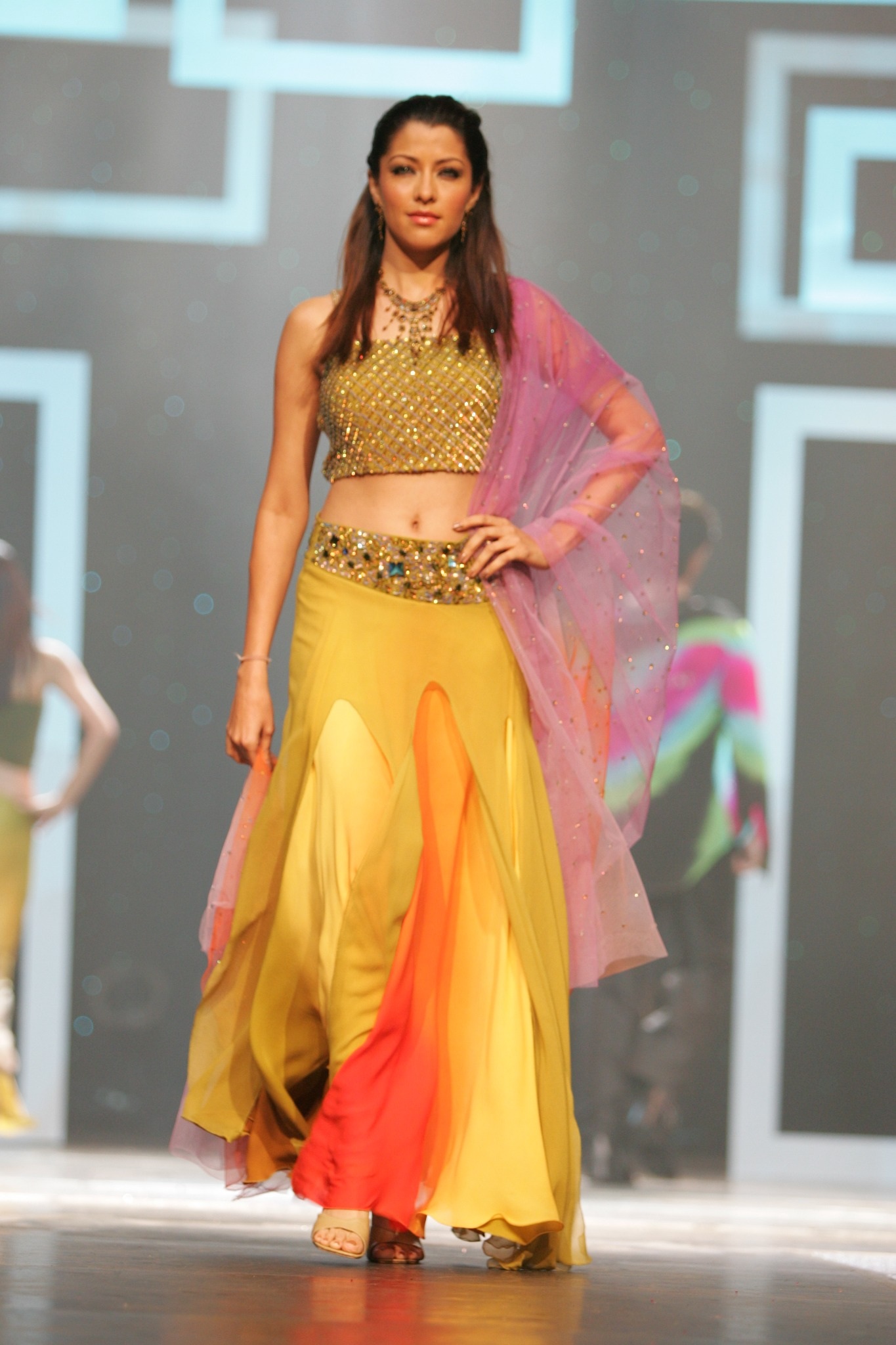 Model wearing yellow and red ensemble from an early Alia Qureshi runway collection