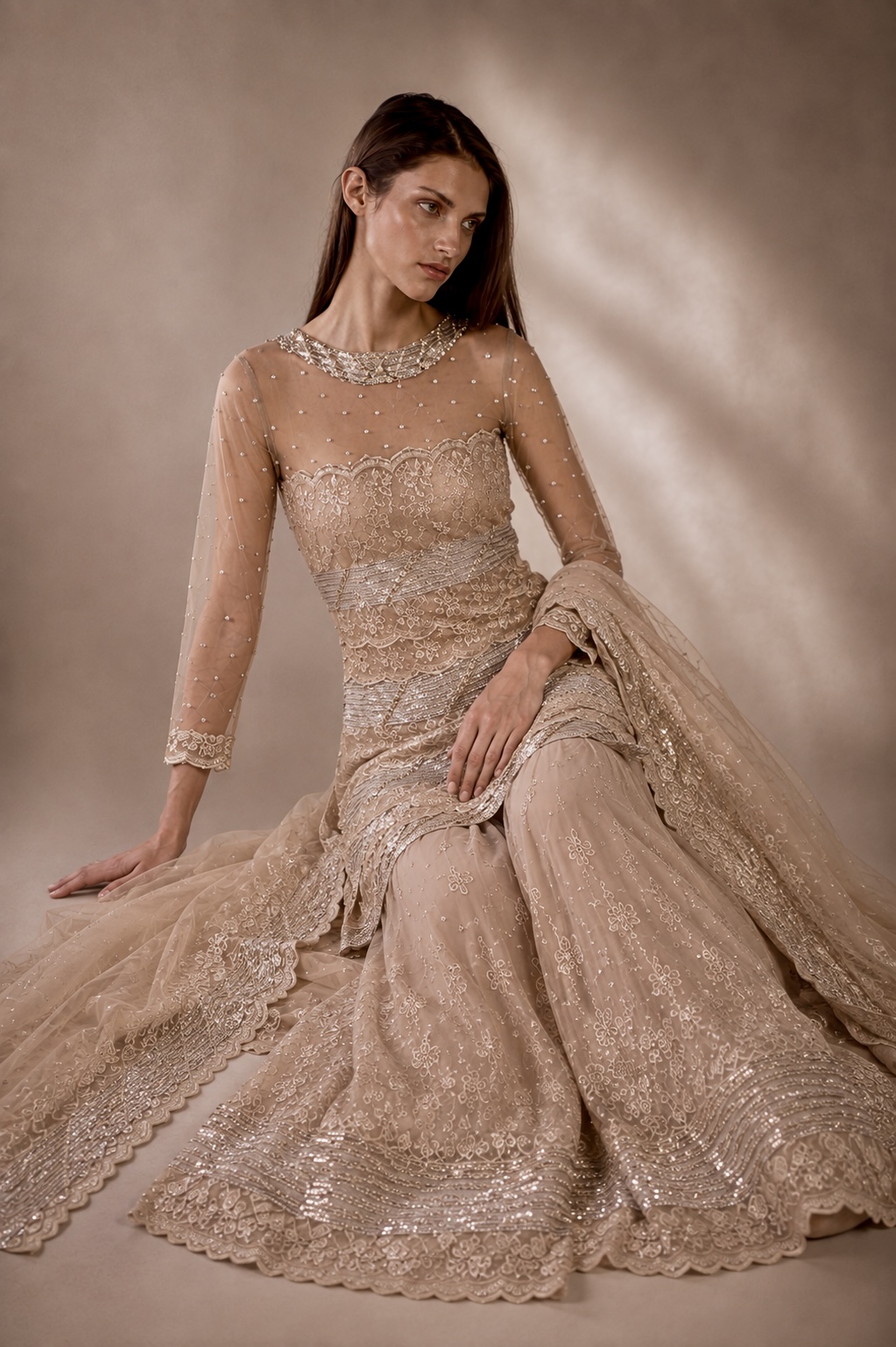 Seated view of champagne embroidered couture ensemble from Éclat Sculpté by Alia Qureshi Atelier