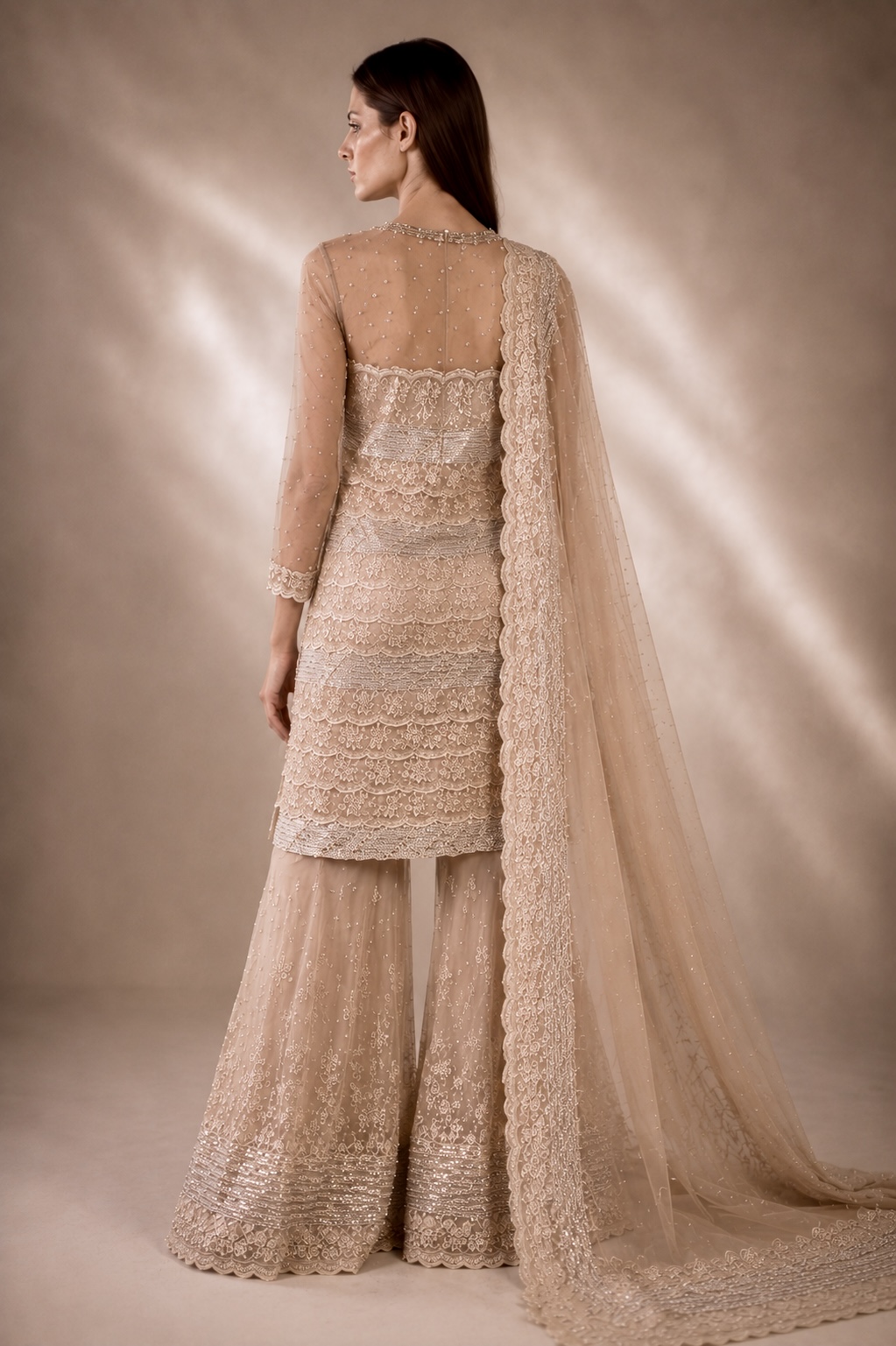 Back view of champagne embroidered couture ensemble with sheer dupatta from Éclat Sculpté by Alia Qureshi Atelier