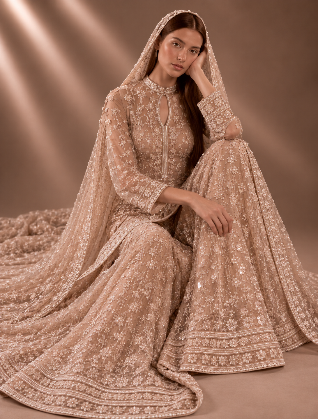 Seated view of nude blush and pearl embroidered couture ensemble from Élan de Perle by Alia Qureshi Atelier