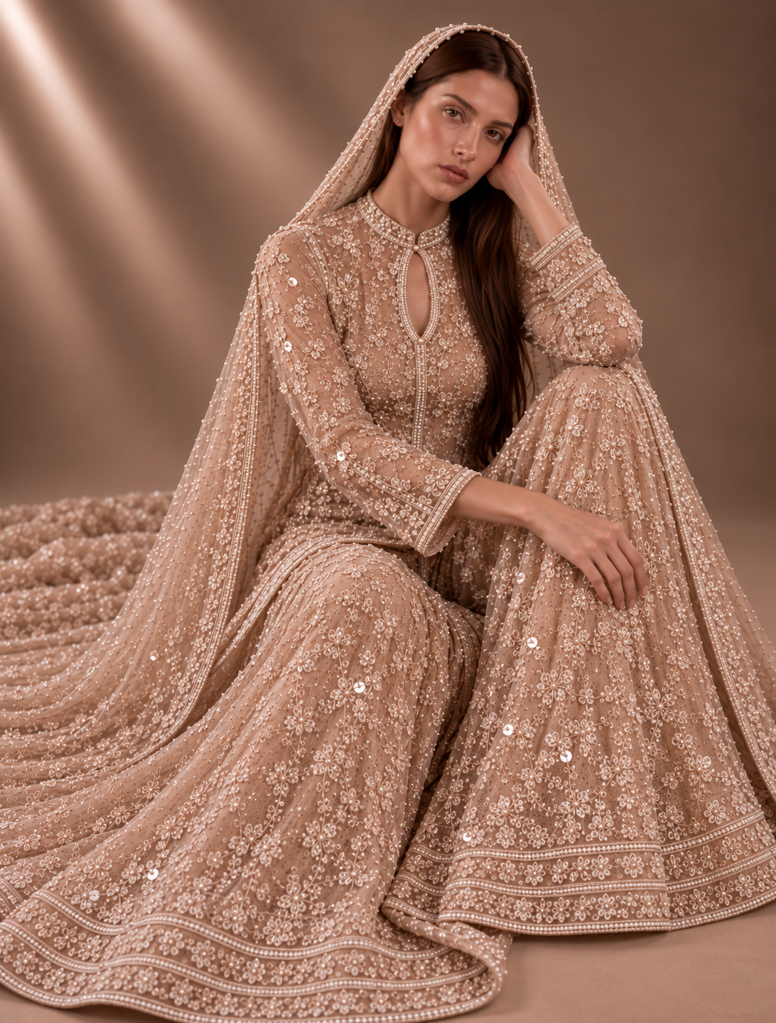 Seated view of nude blush and pearl embroidered couture ensemble from Élan de Perle by Alia Qureshi Atelier