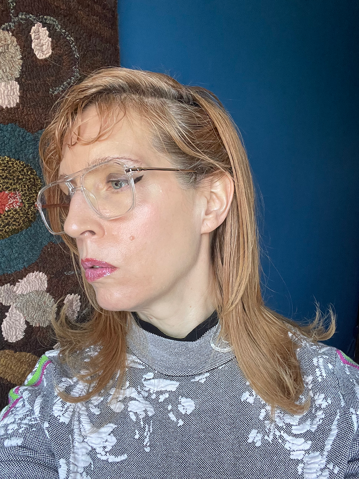Olivia Barr at home with handmade hook rug tapestry by Pat Laska