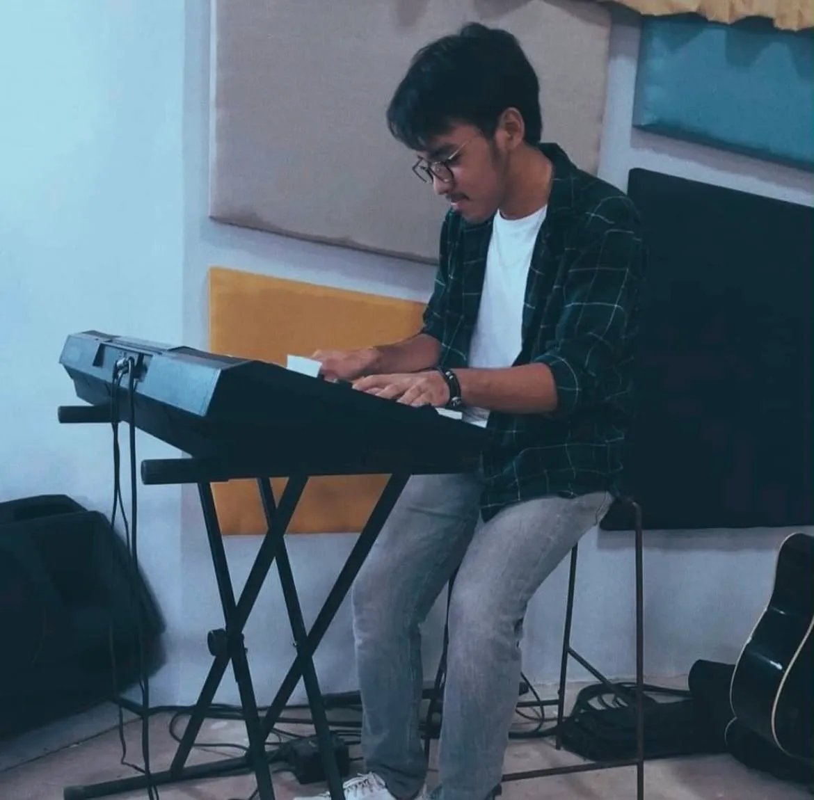An image of Eugene playing the electric piano.