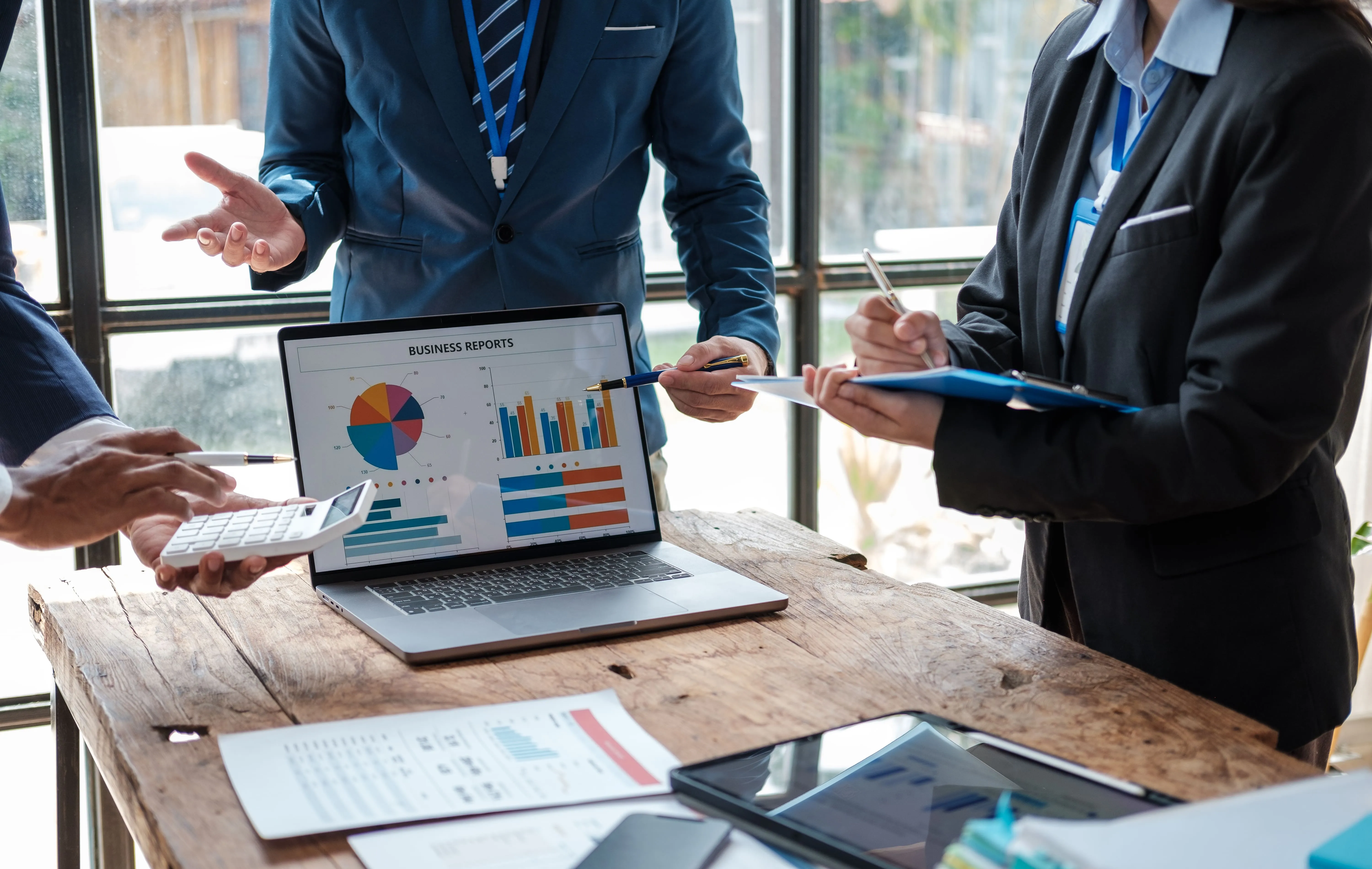 Business leaders reviewing performance reports, financial data and growth metrics during a strategy meeting.