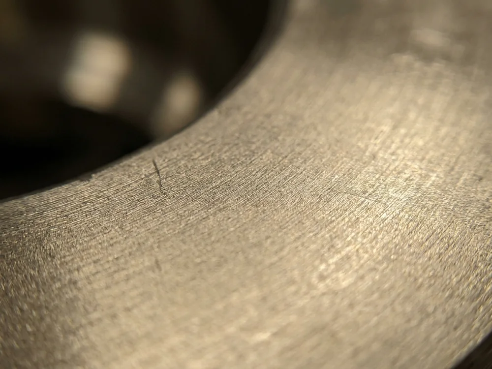 Machined nickel alloy surface with a warm gray finish