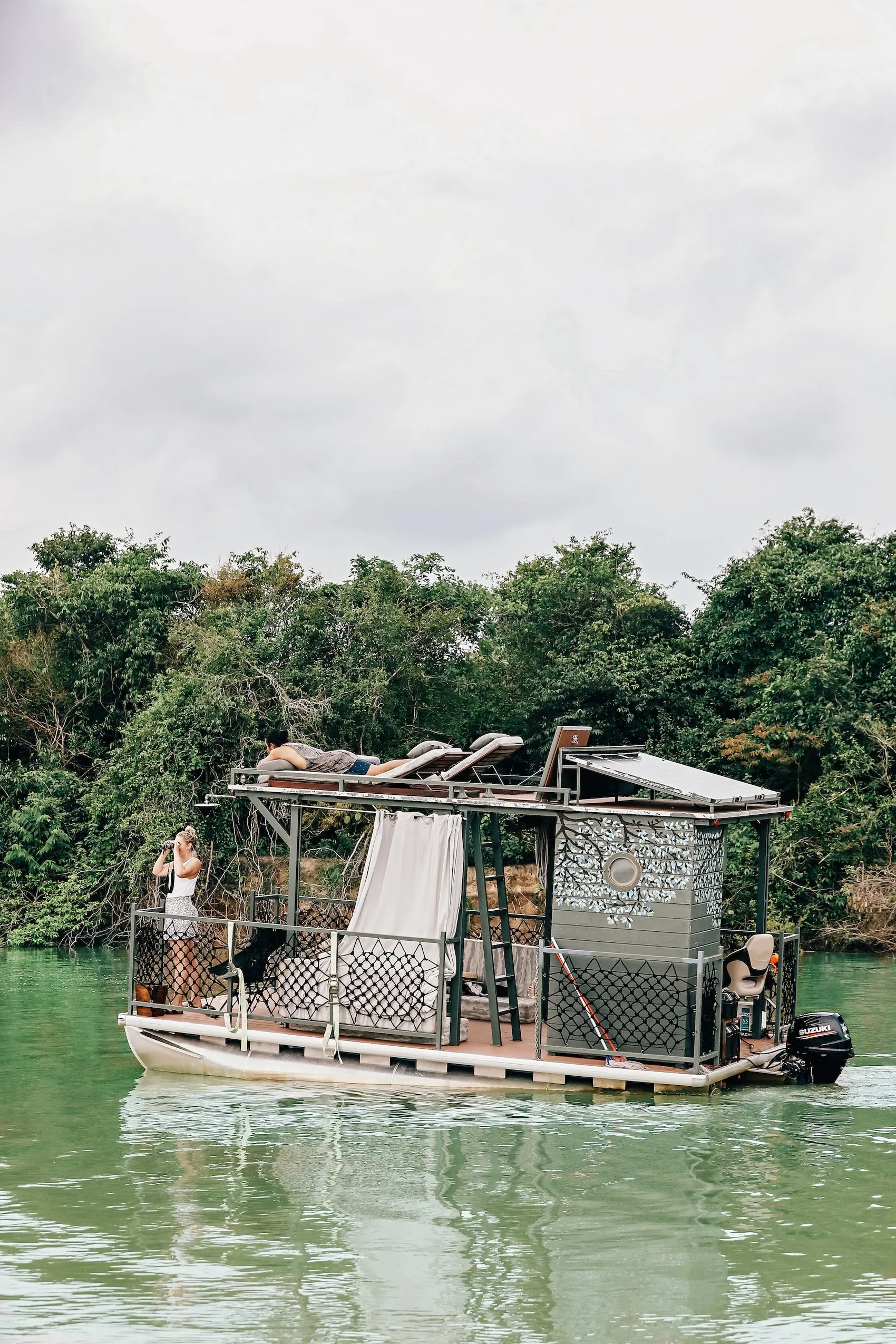 A river excursion boat surrounded by forest