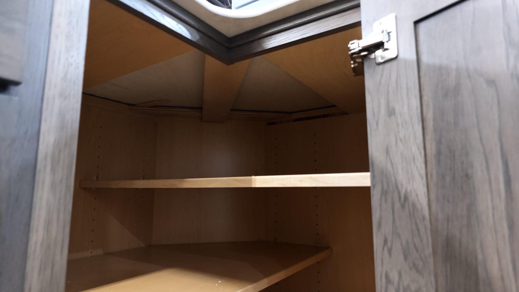 Split corner shelves running in two directions inside a corner cabinet