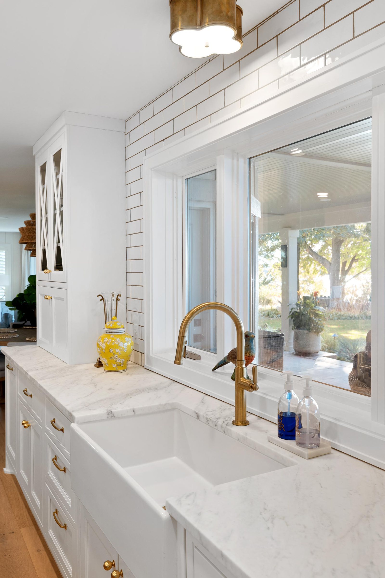 Cambria quartz countertop and farmhouse sink in a bright white kitchen