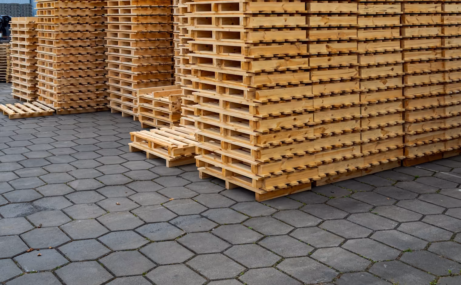Große Stapel neuer Holzpaletten auf einem Außengelände