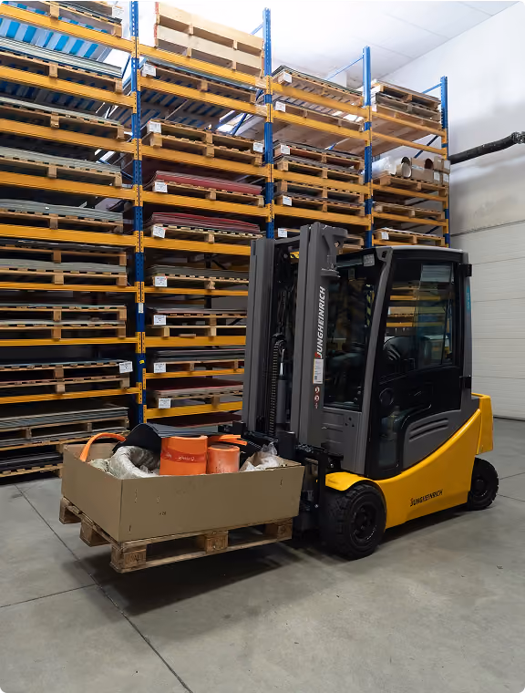 Forklift moving a pallet through high-bay racking