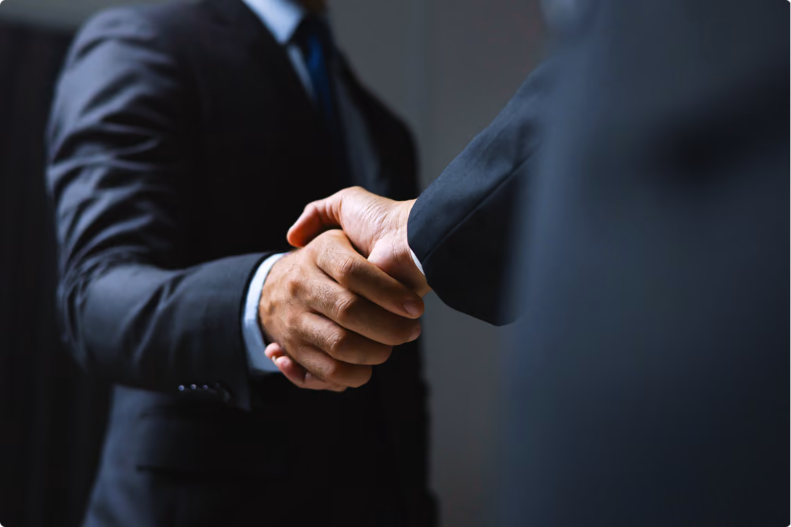 Two business partners in suits shaking hands