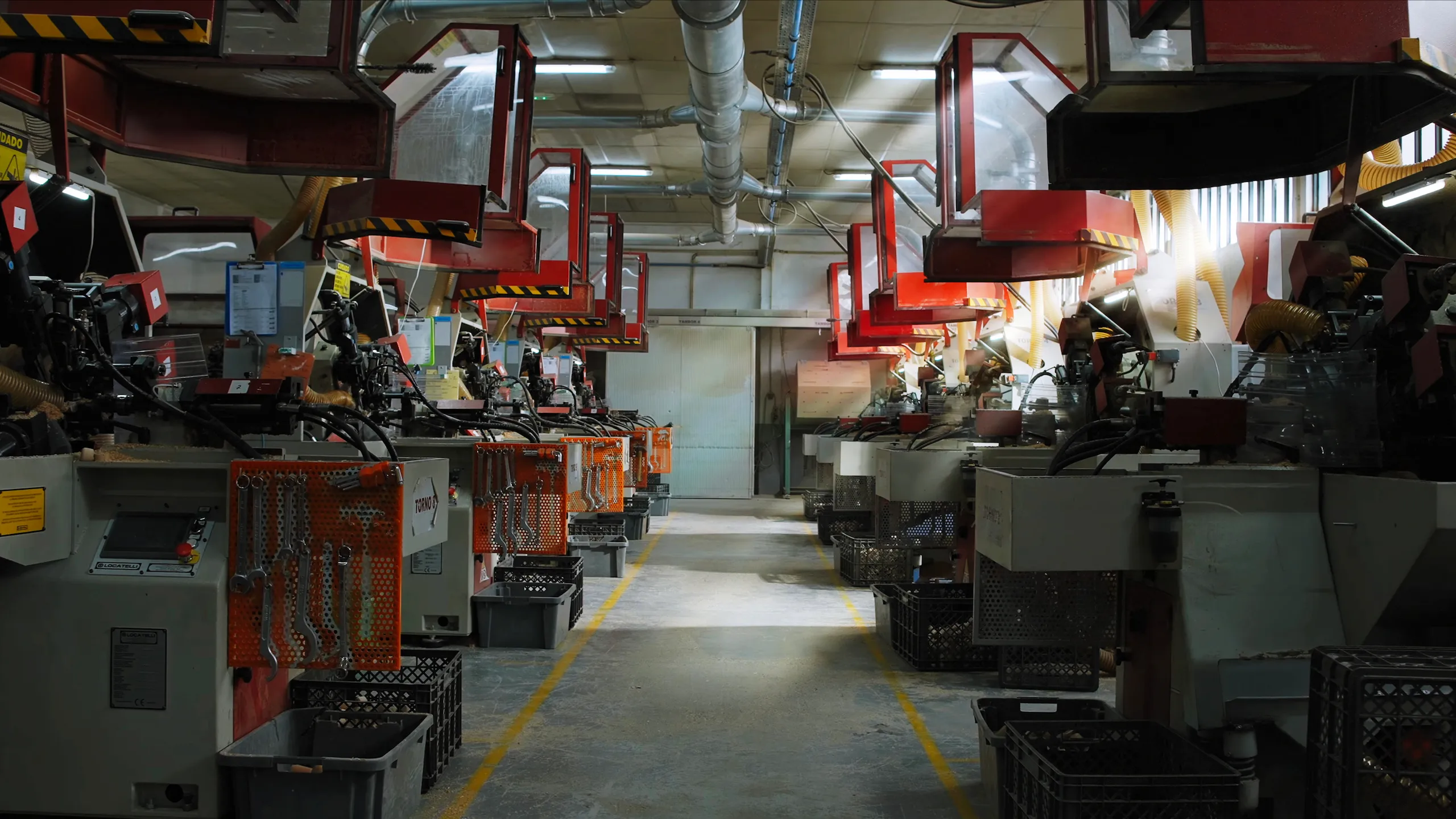 Interior of a manufacturing workshop with rows of industrial machines on both sides