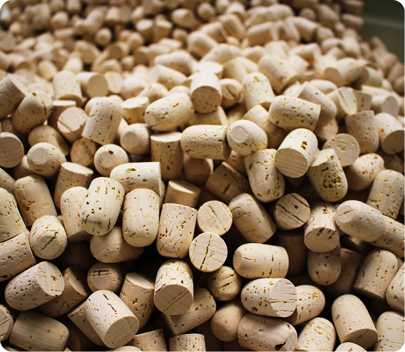 Close-up of a light brown cork against a gradient black and brown background.