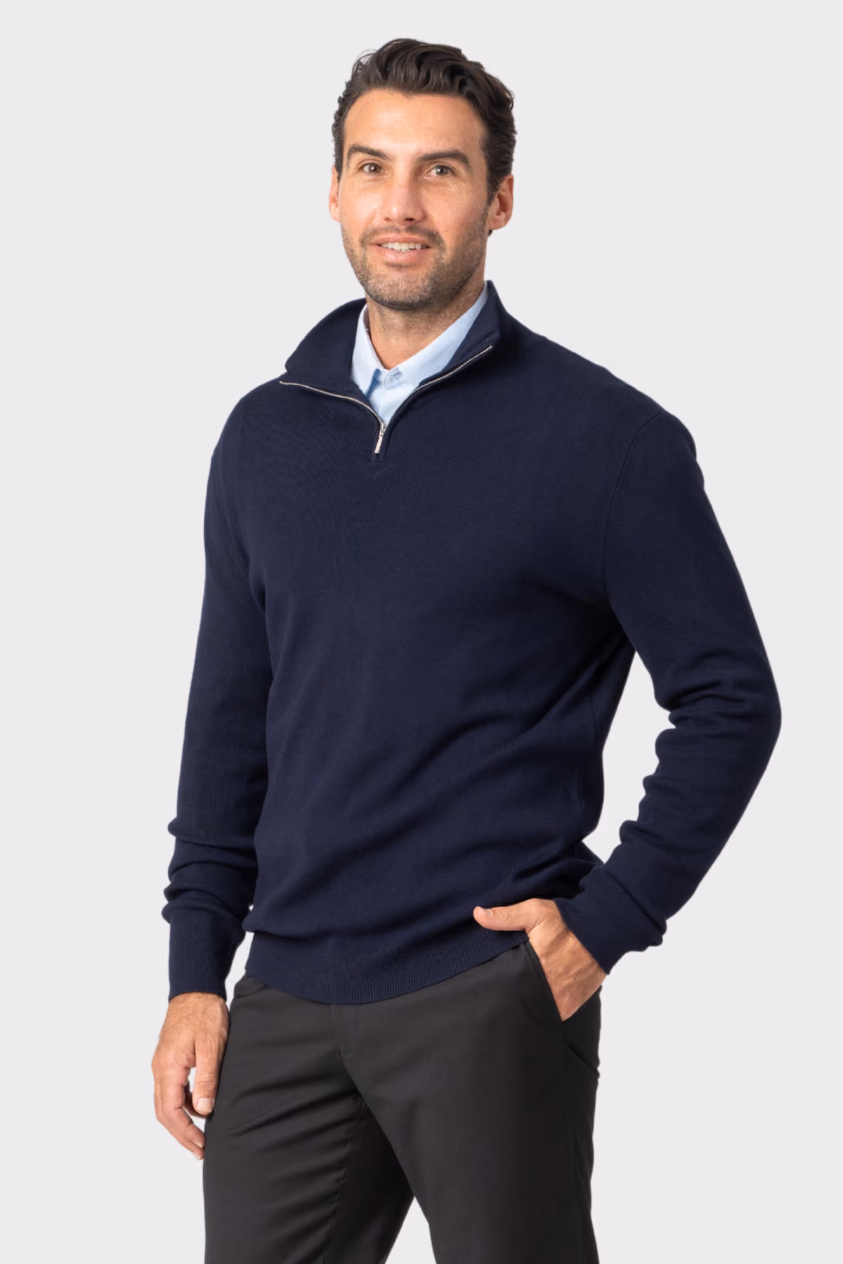 Man wearing a navy quarter-zip corporate pullover over a collared shirt
