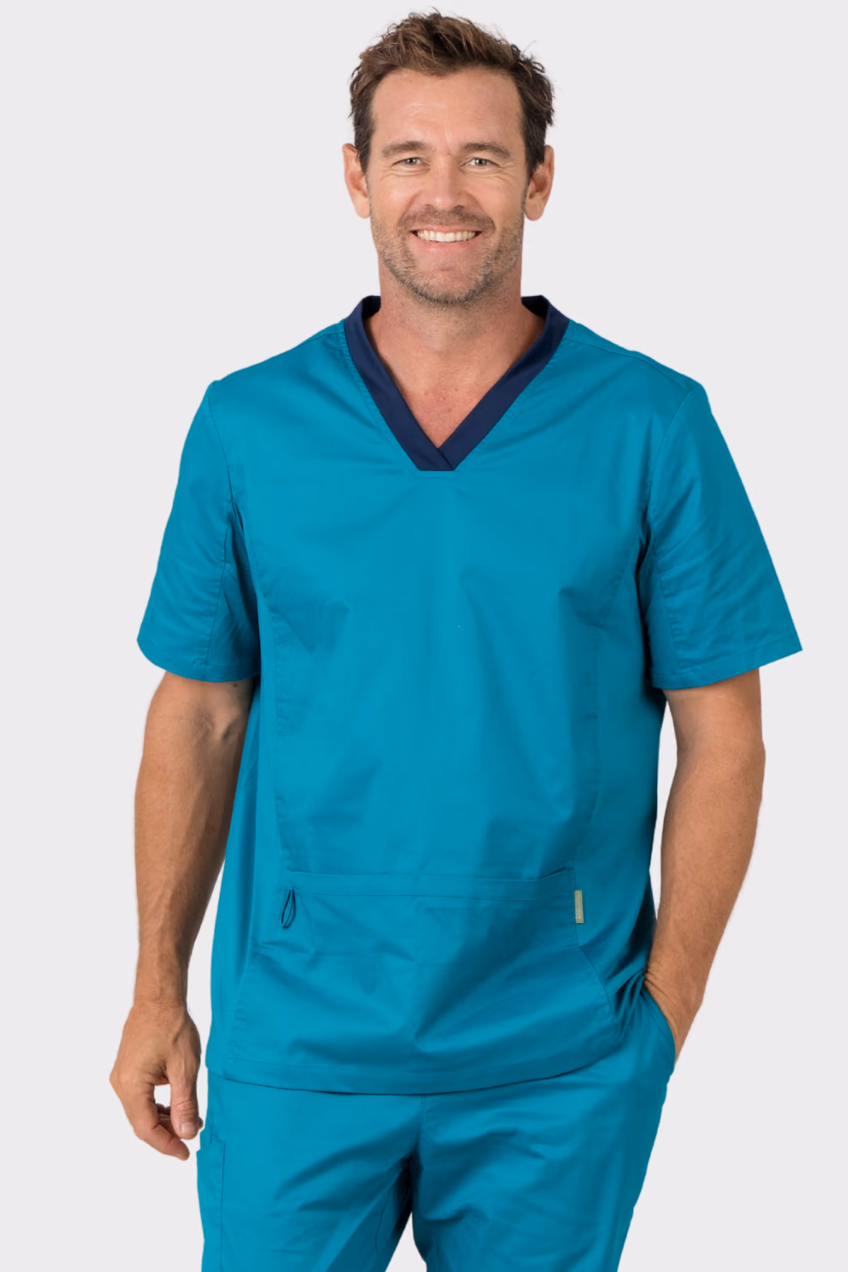 Man wearing a teal V-neck aged care scrub top with matching trousers
