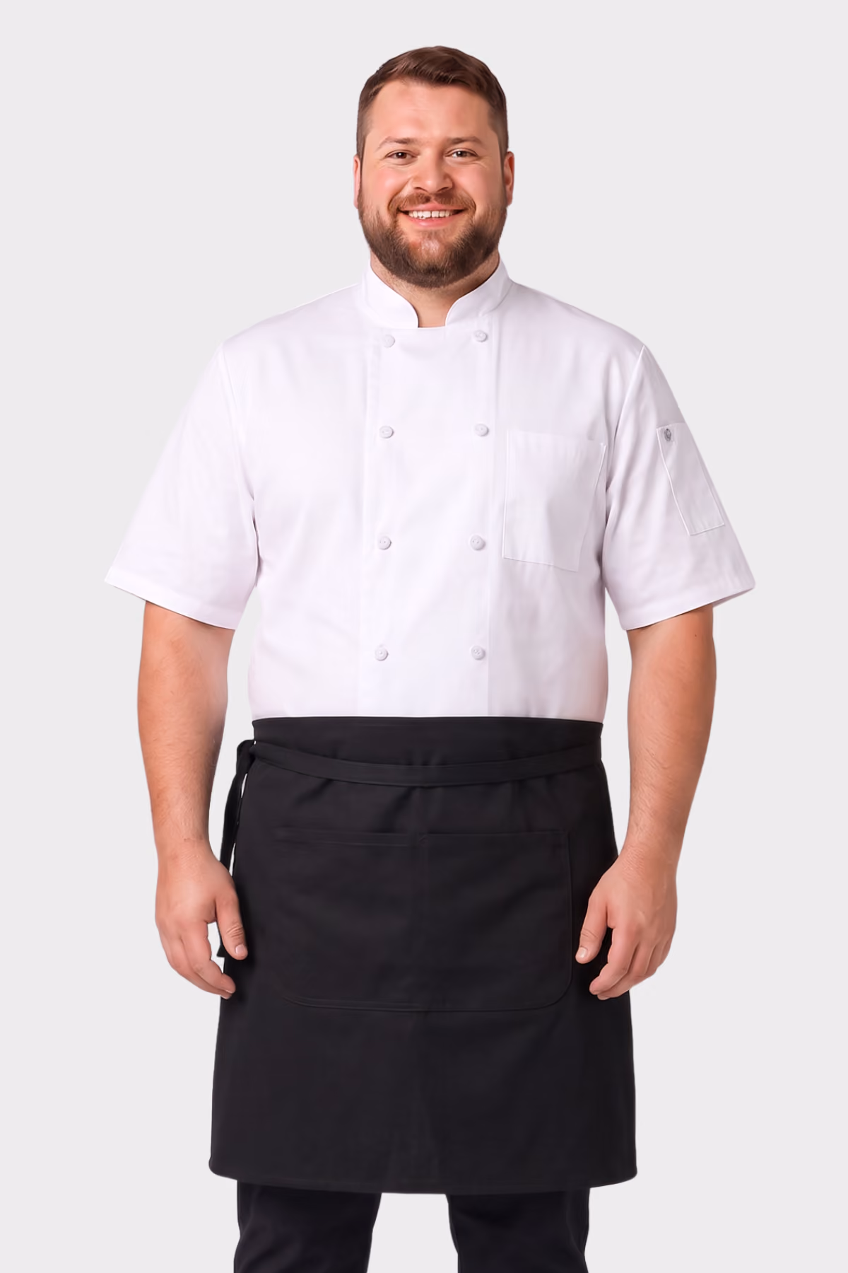 Man wearing a white short-sleeve chef jacket with a black waist apron