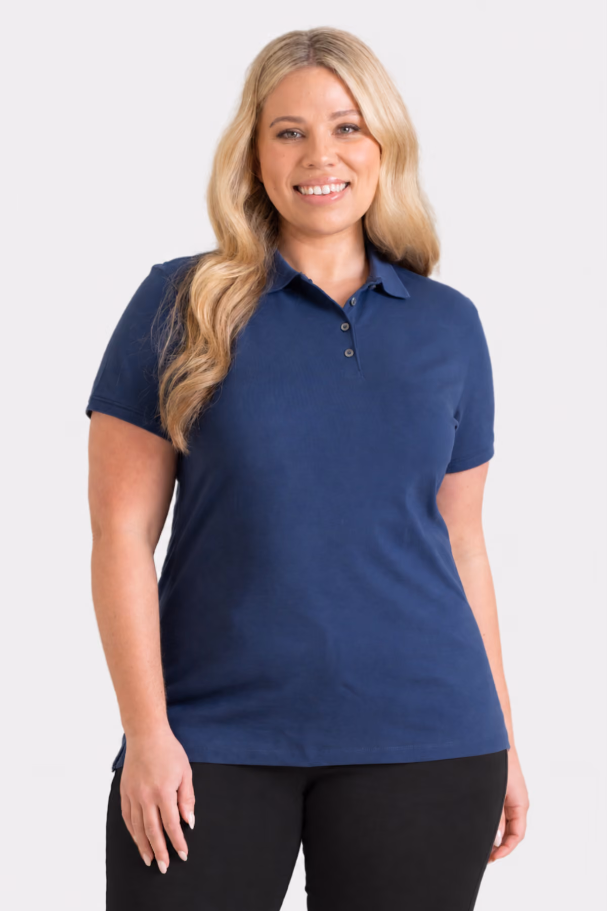 Woman wearing a navy short-sleeve early learning polo shirt with black trousers