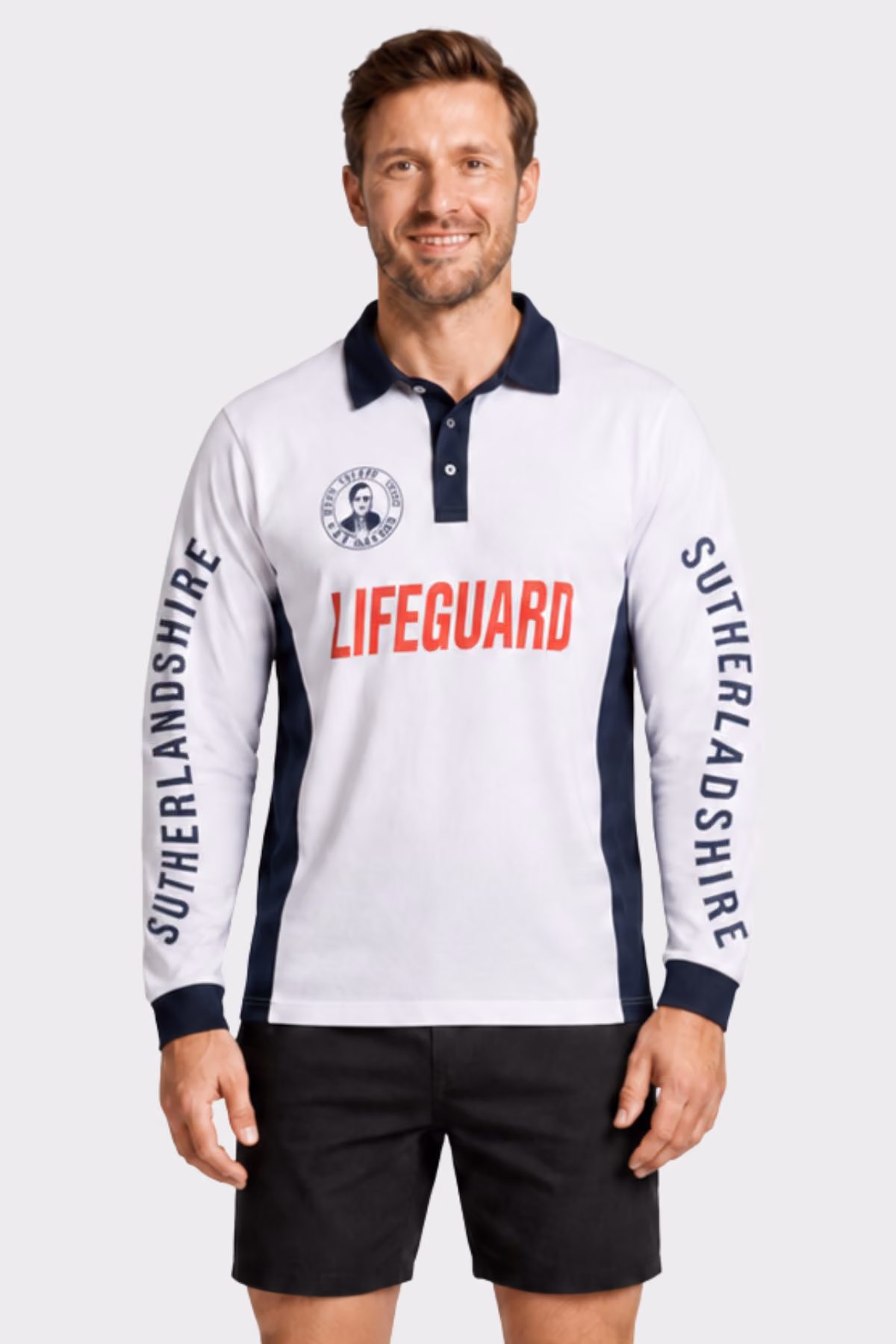 Man wearing a white and navy long-sleeve lifeguard shirt with black shorts