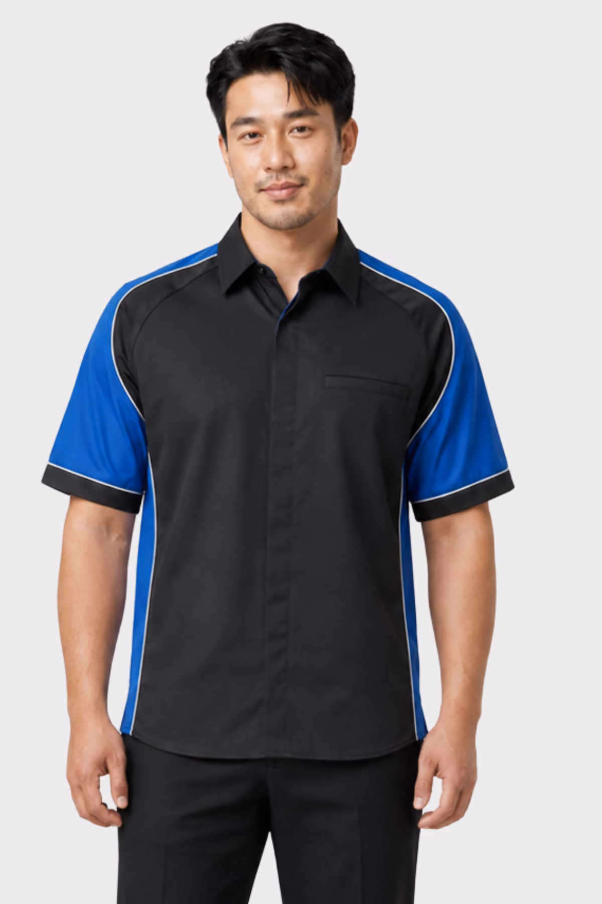Man wearing a black and blue panelled automotive work shirt with black trousers