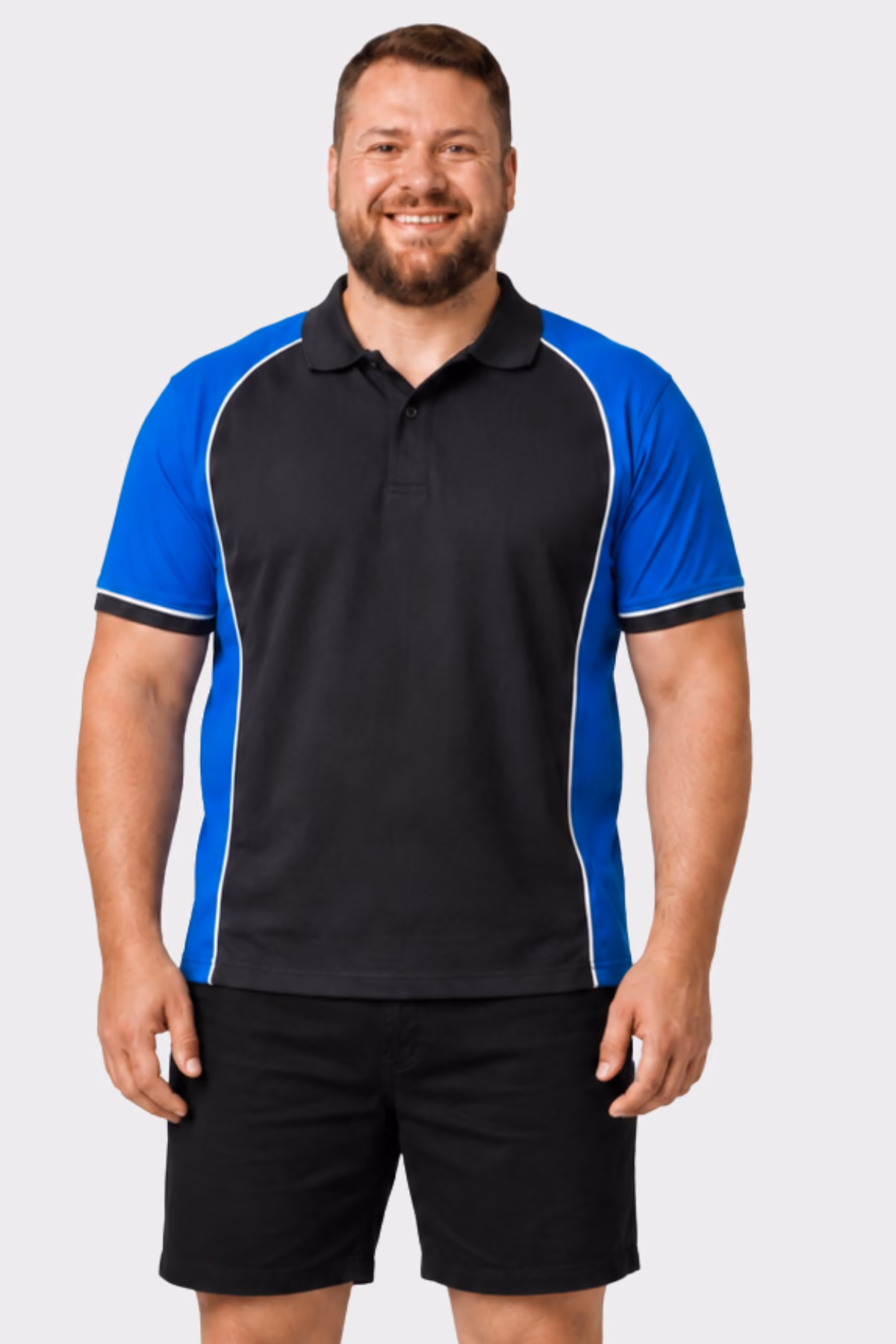 Man wearing a black and blue panelled automotive polo with black shorts