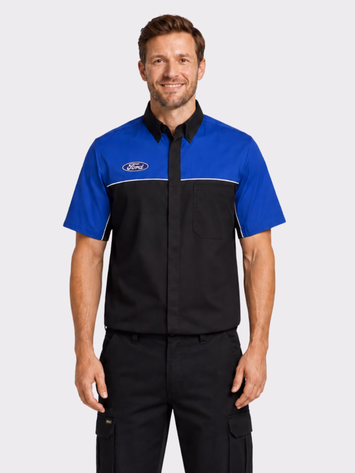 Man wearing a black and blue branded automotive work shirt with black cargo trousers