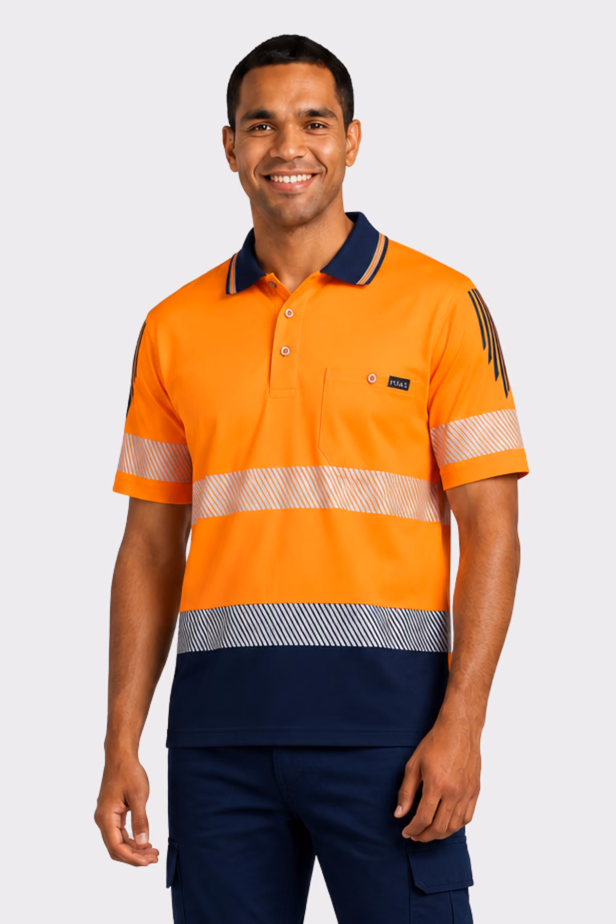 Man wearing an orange and navy hi-vis polo with reflective tape and navy cargo trousers
