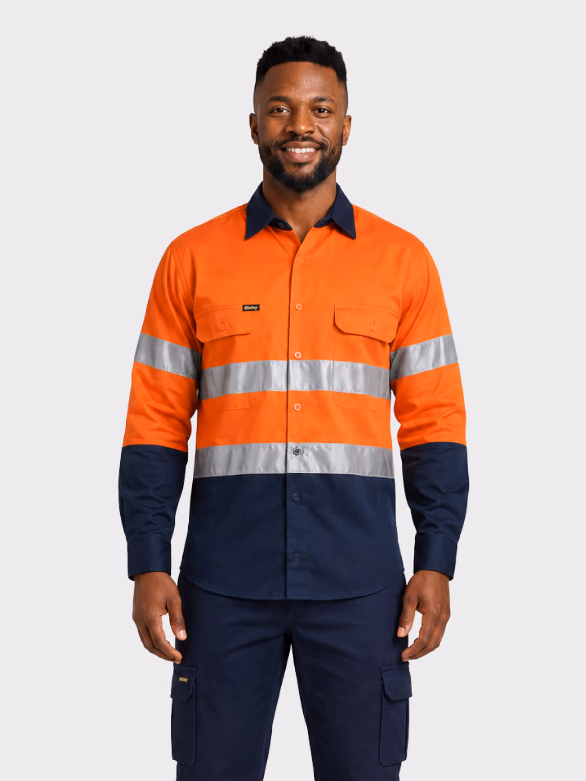 Man wearing an orange and navy hi-vis long-sleeve work shirt with reflective tape