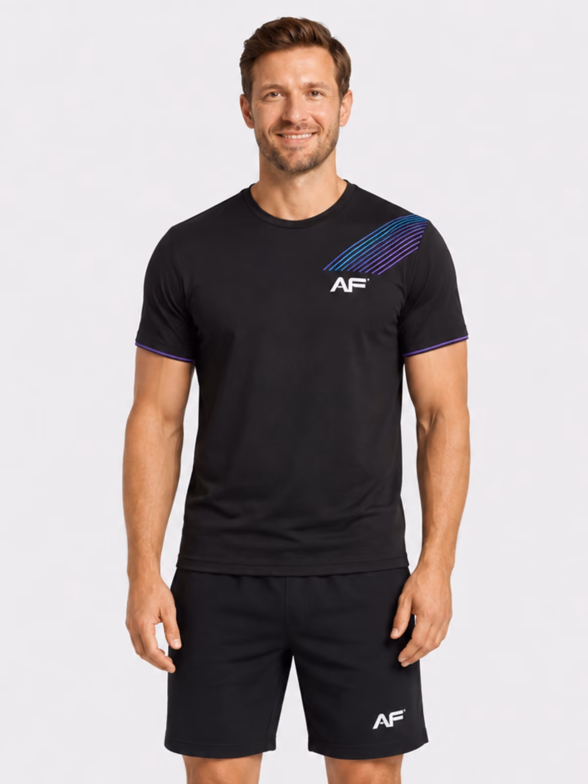 Man wearing a black branded fitness t-shirt with black shorts