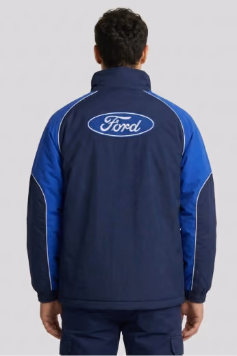 Back view of a man in a navy and blue Ford-branded automotive jacket