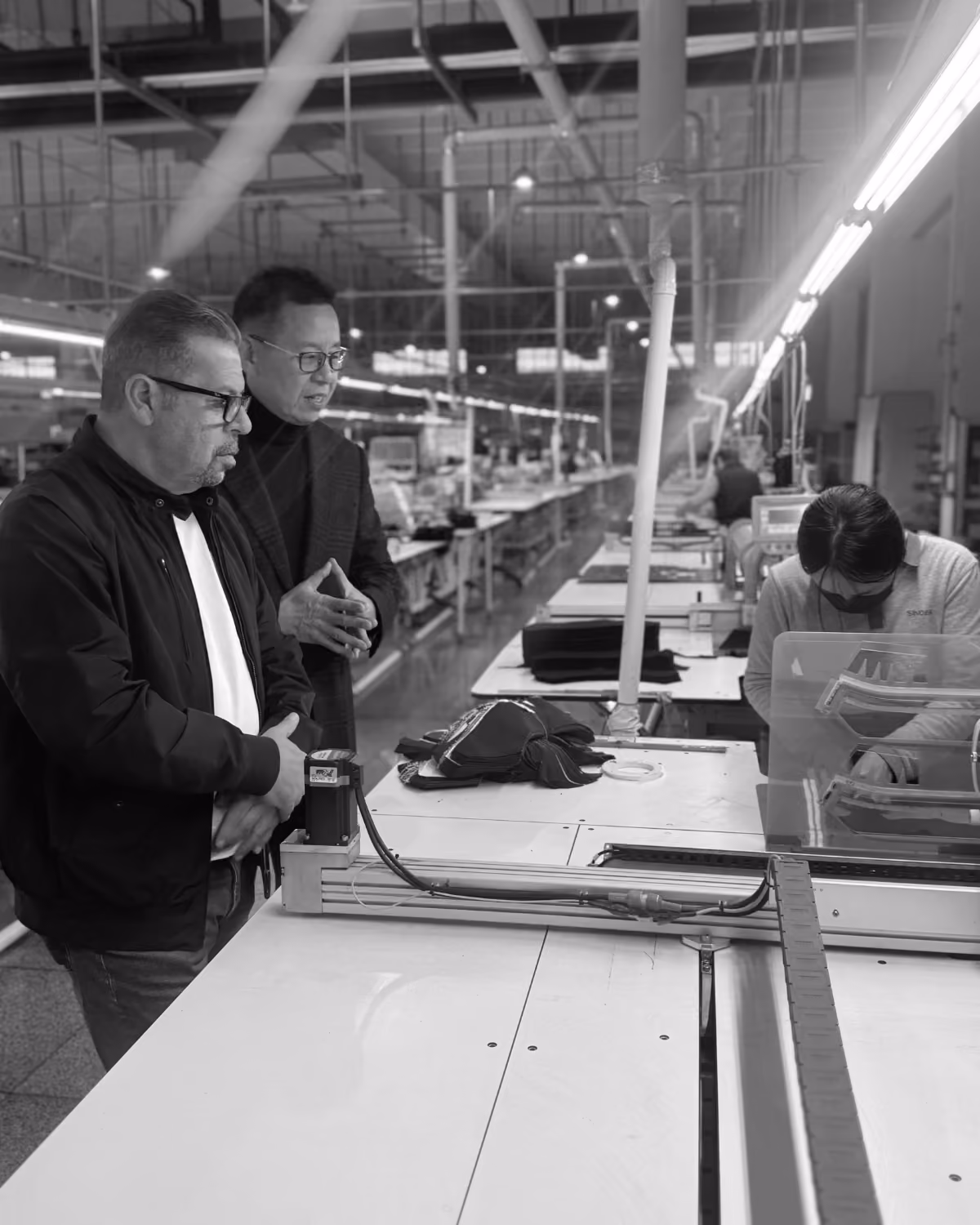 Team members inspecting garments on a factory production floor