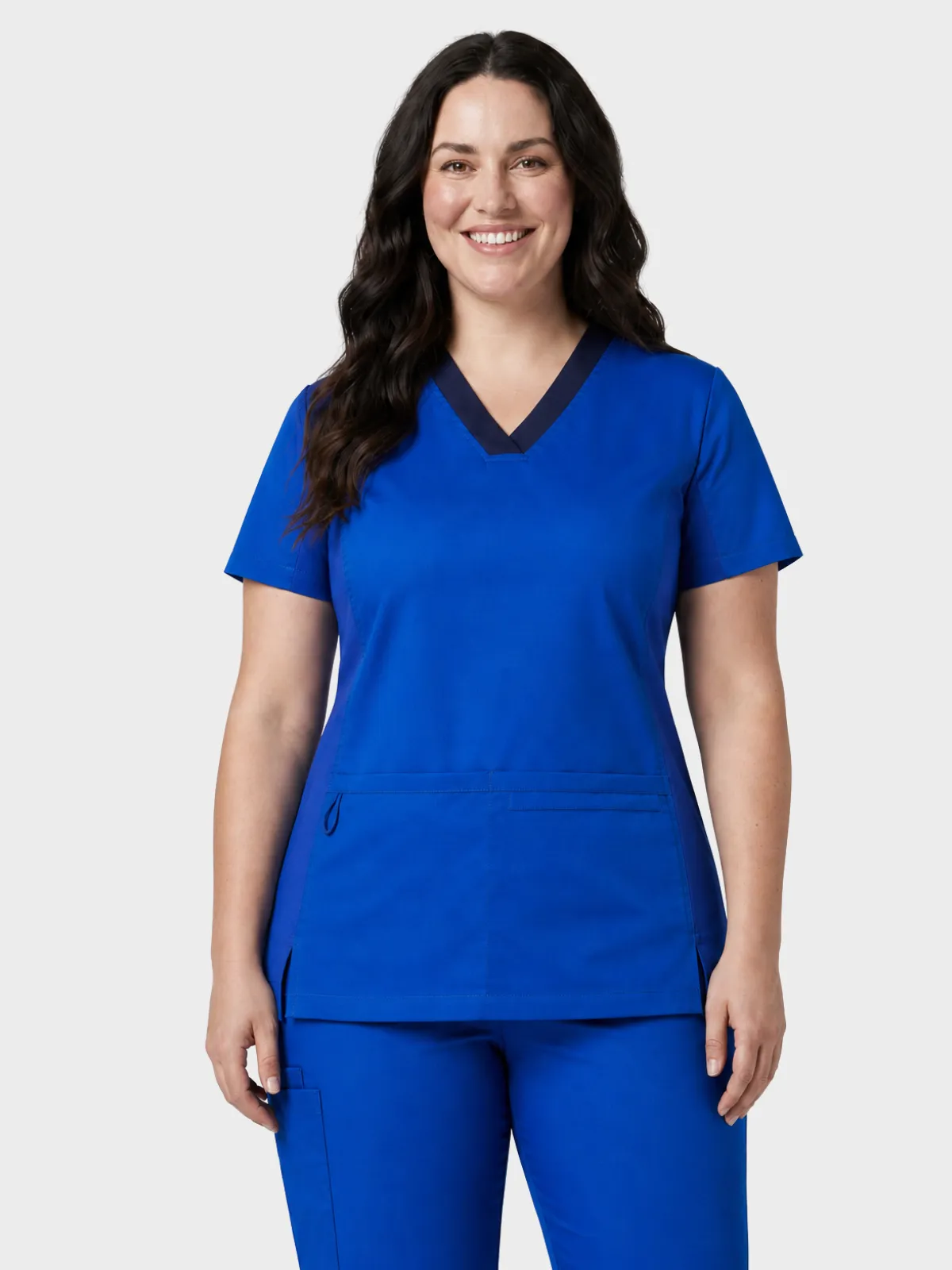 Woman wearing royal blue healthcare scrubs with a navy V-neck trim