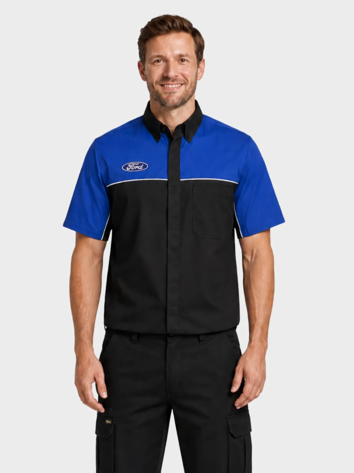 Man wearing a blue and black Ford-branded automotive work shirt with black cargo trousers