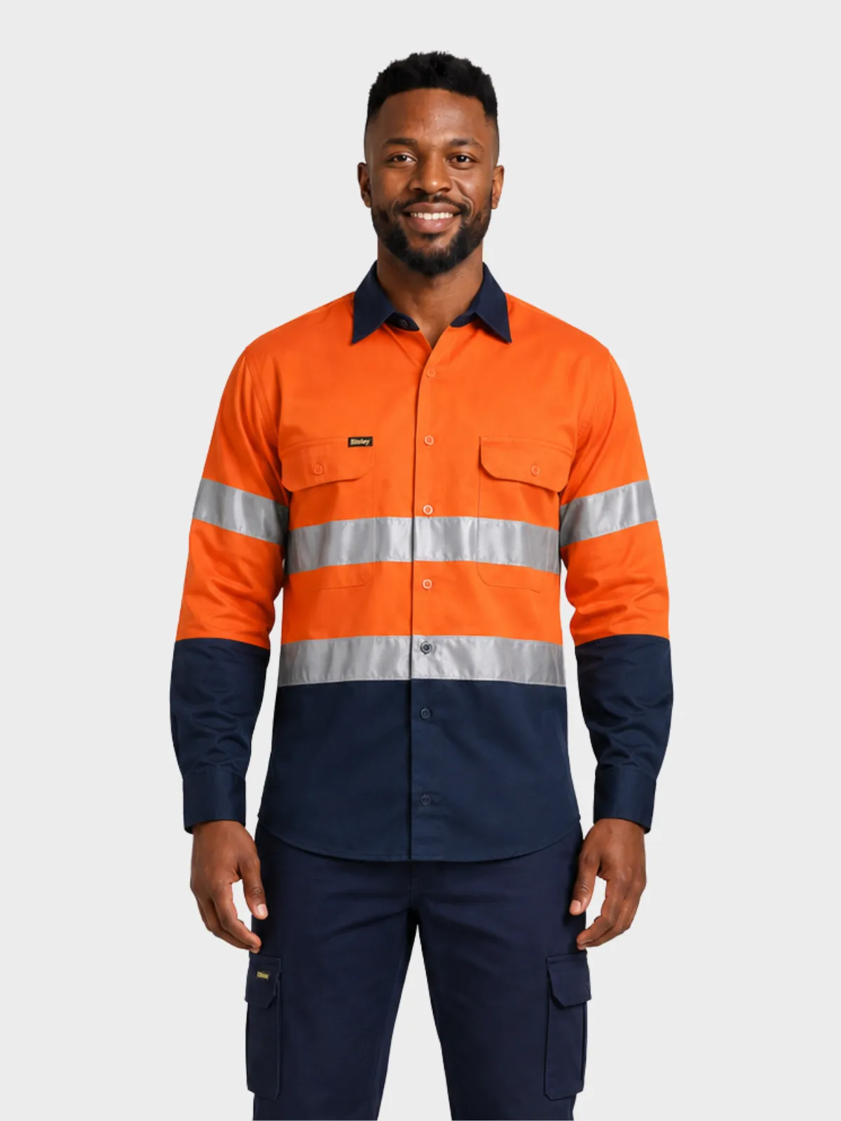 Man wearing an orange and navy hi-vis long-sleeve work shirt with reflective tape