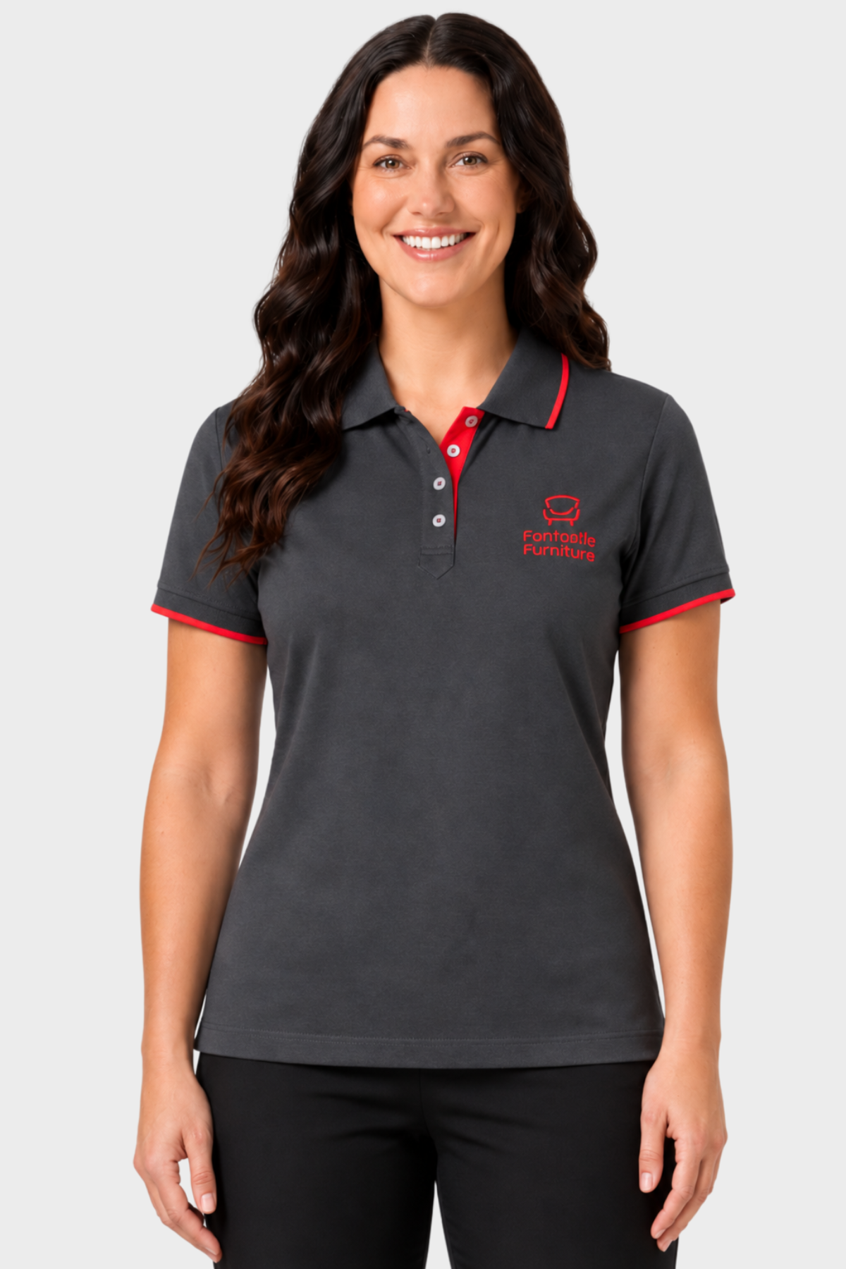 Woman wearing a charcoal branded retail polo with red trim and black trousers
