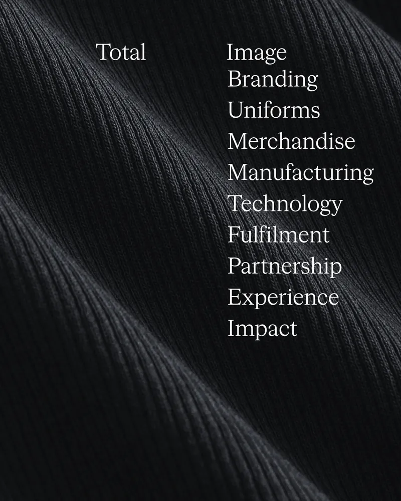 Black ribbed knit fabric with the words Total Image, Branding, Uniforms and Merchandise