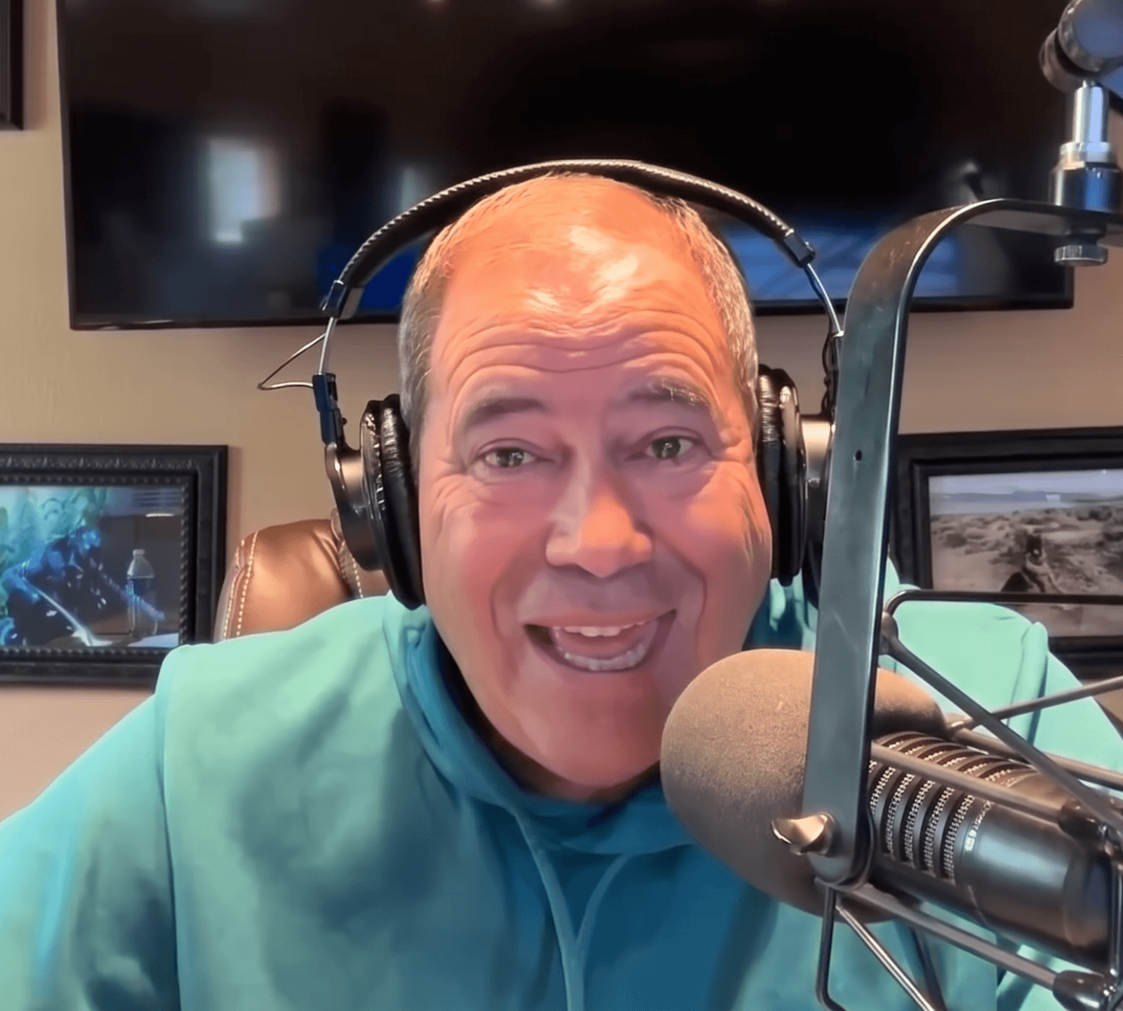 Jon Sanchez smiling at the mic in his studio