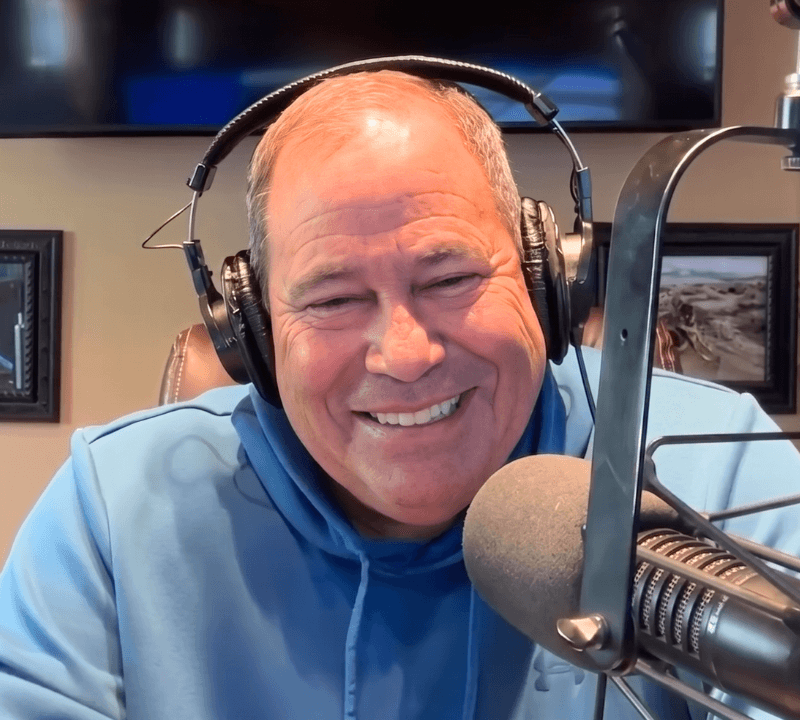 Jon Sanchez smiling at the studio mic