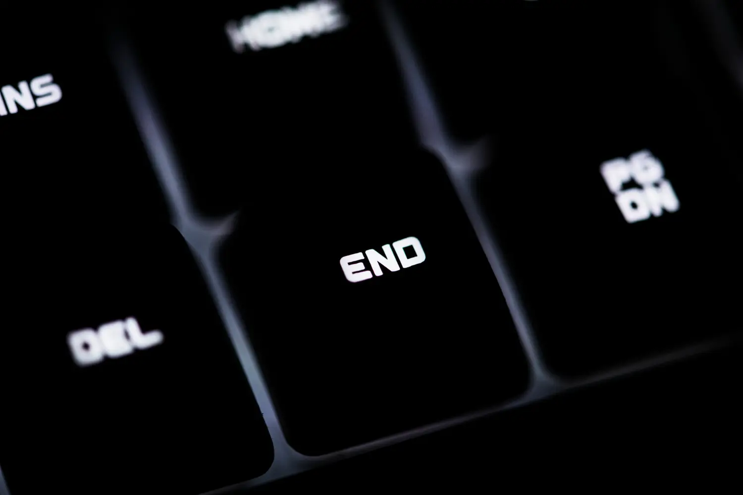 Close-up of black keyboard keys with white letters including the END key in focus.