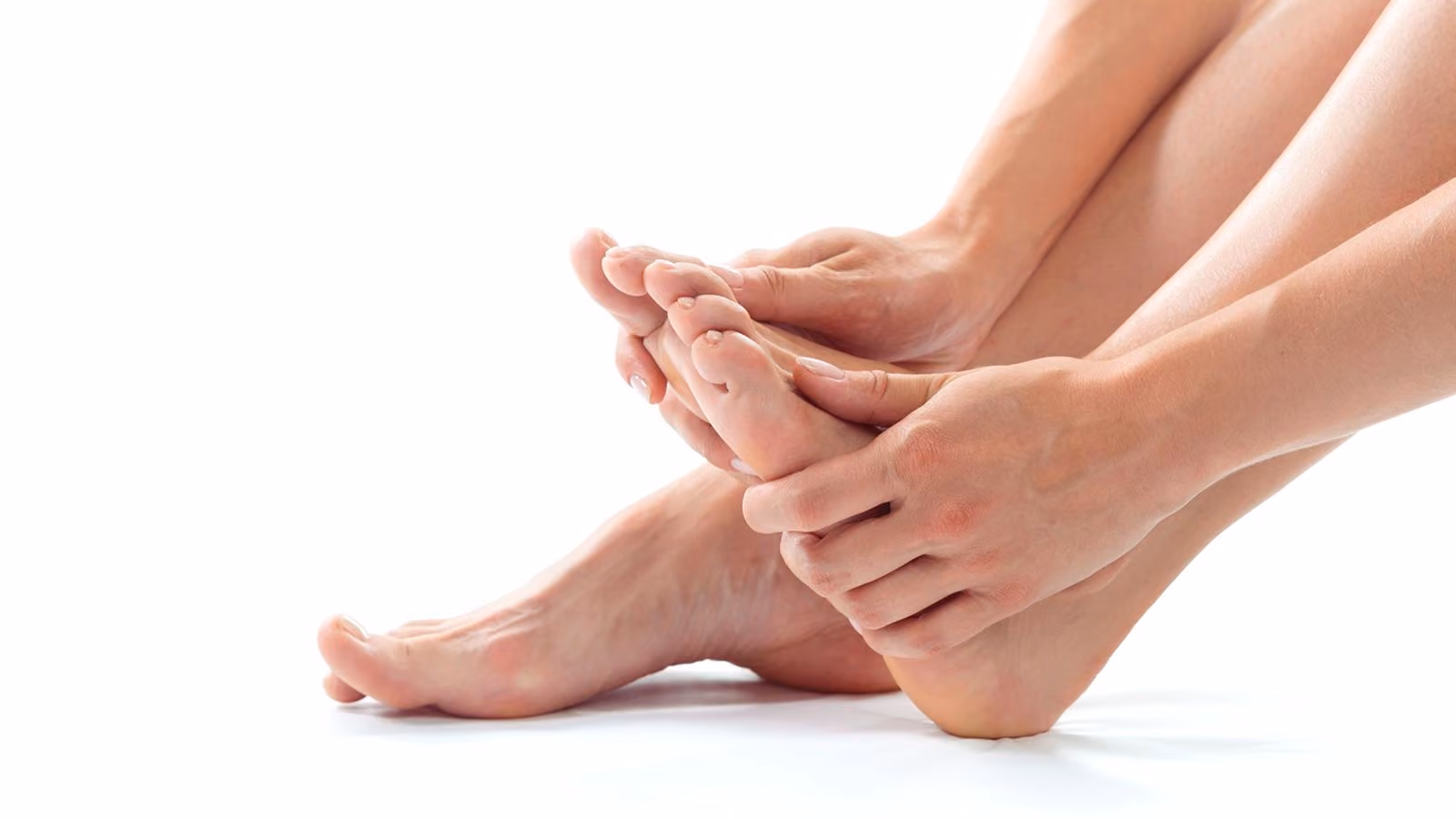 A woman holding her foot like it is in pain